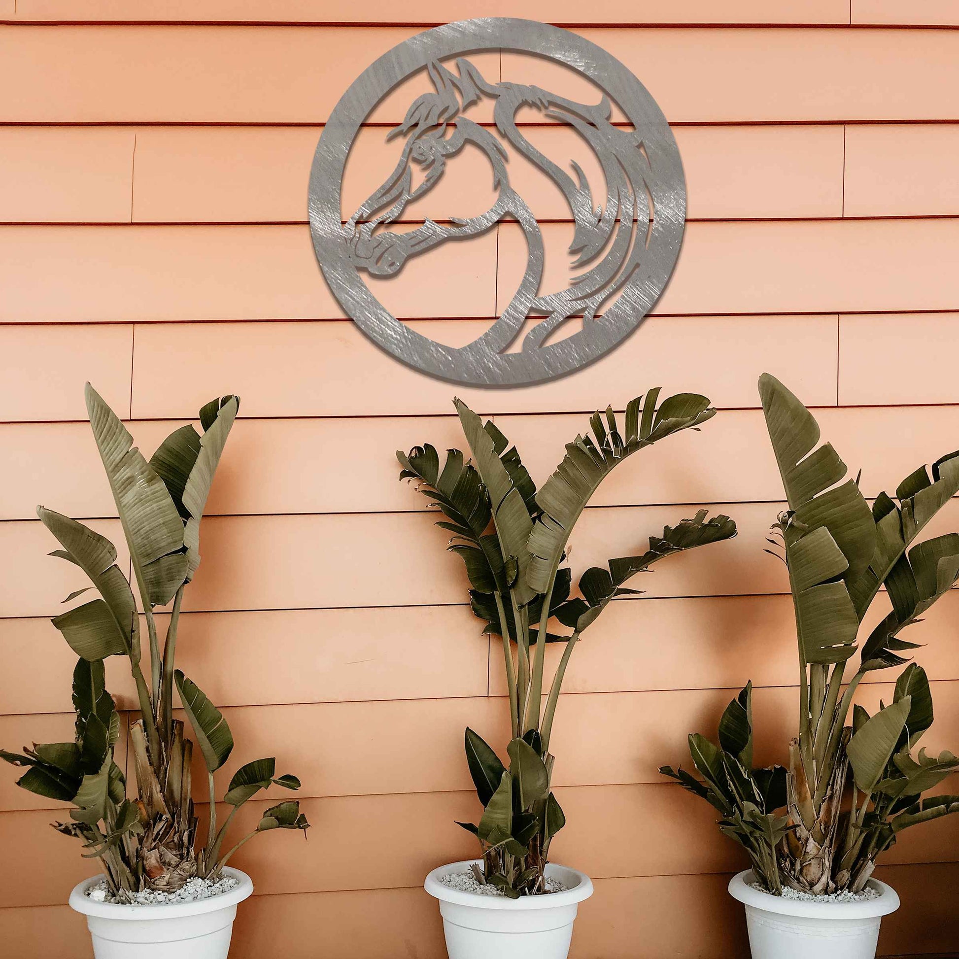 Metal wall art featuring a detailed horse's head within a circular frame, designed with flowing lines and intricate details, perfect for horse lovers.