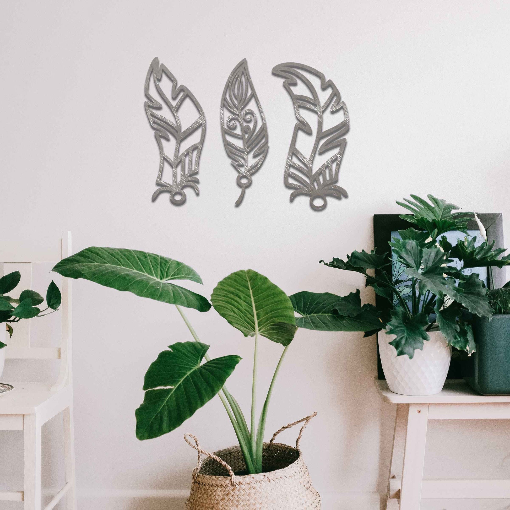 This design features three elegantly styled feathers, each with intricate patterns. The flowing lines and curved shapes give a sense of movement, making the artwork a beautiful representation of nature's delicate beauty.