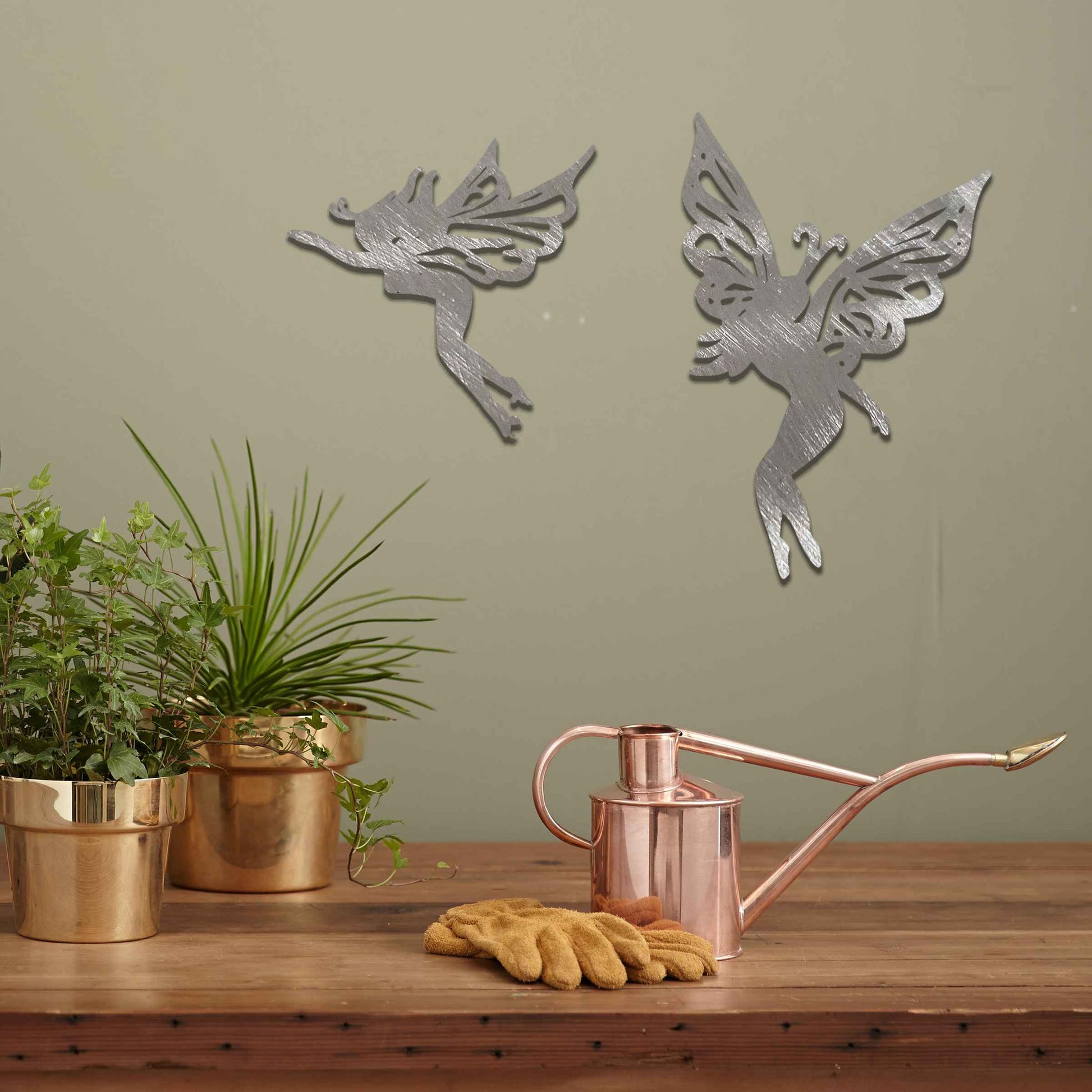 The image depicts two graceful fairies with intricate wings, suspended in mid-air. Their delicate, elegant figures evoke a sense of lightness and magic, adding a whimsical touch to any space, perfect for creating an enchanting atmosphere.