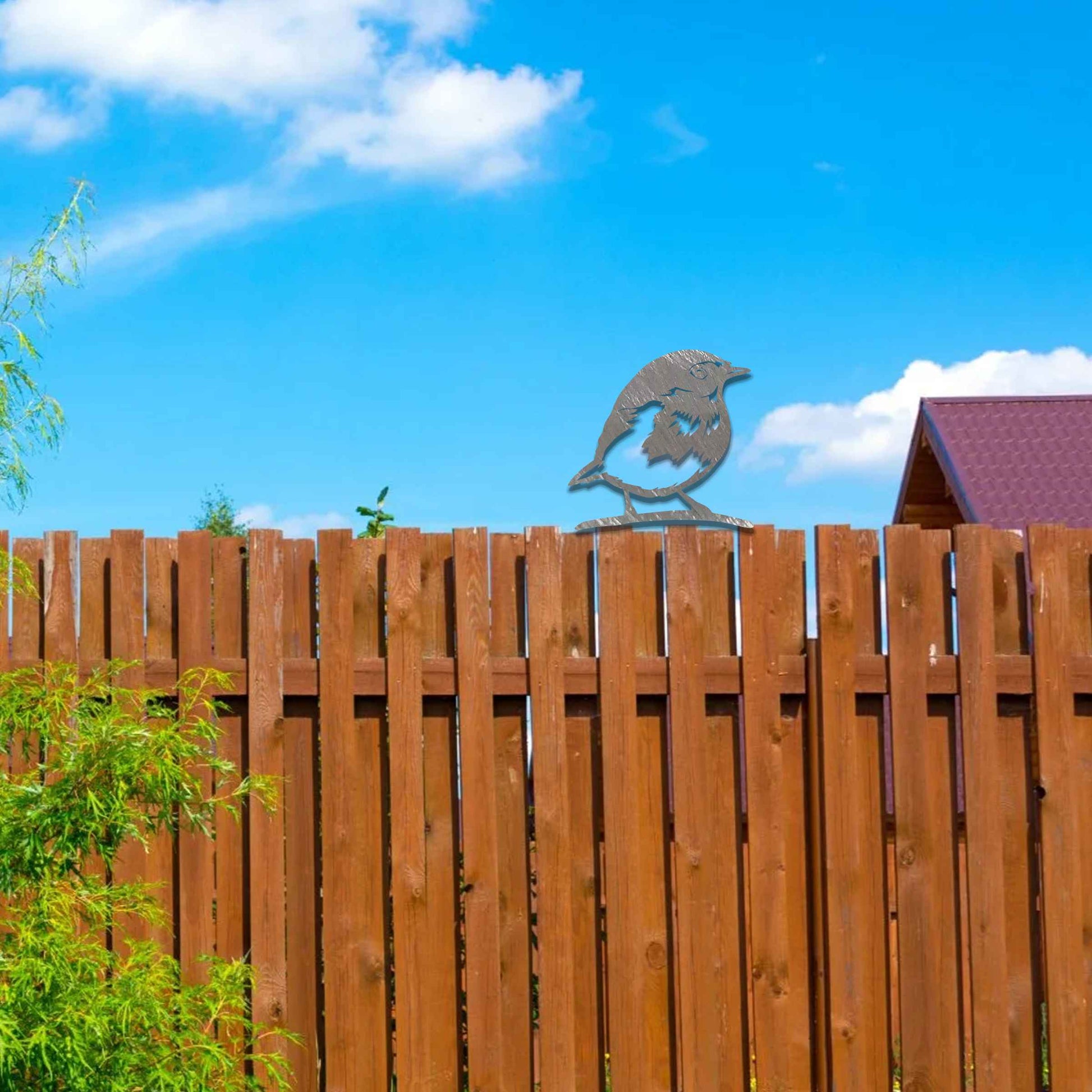 Metal garden decoration featuring a robin silhouette with a rustic finish, designed to sit atop fences or posts, adding a charming and natural touch to outdoor garden spaces.