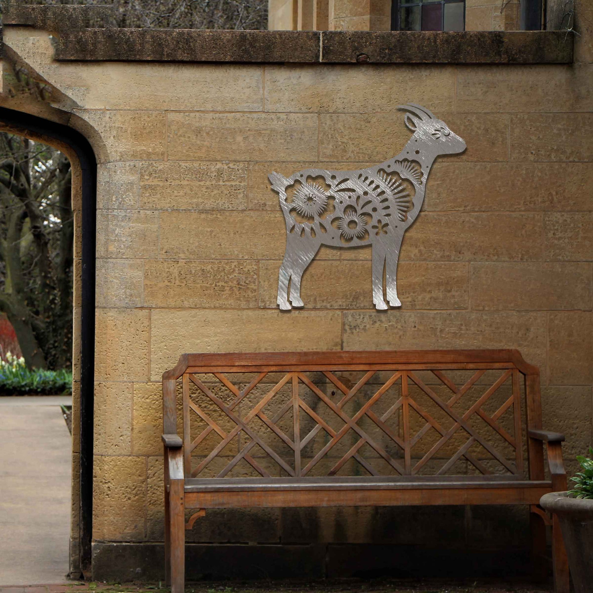 Side profile of a goat, beautifully adorned with intricate floral patterns along its body. The floral design enhances the natural grace of the animal, creating a charming and rustic piece of wall art.