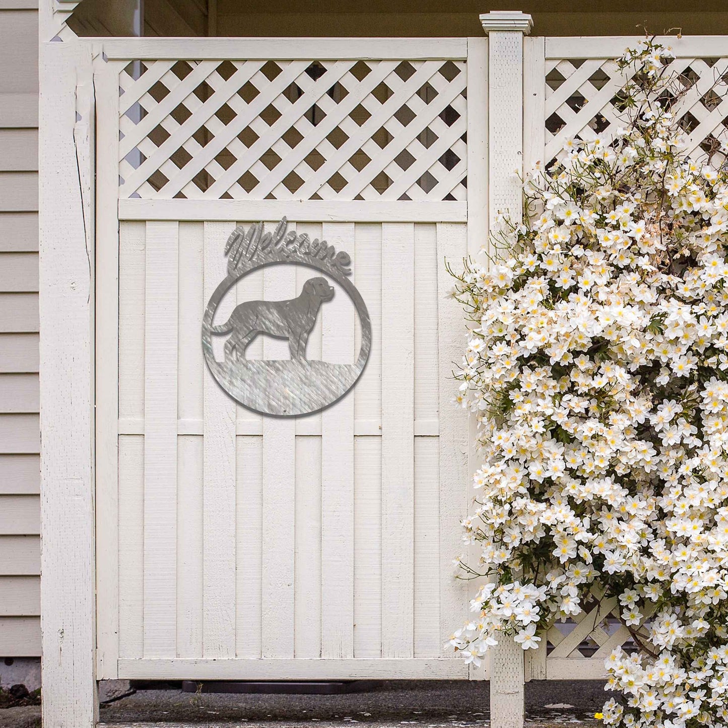 Metal garden art design showcasing a dog silhouette in profile, enclosed within a circular frame. Above the dog, the word Welcome is displayed, creating a warm and inviting atmosphere.