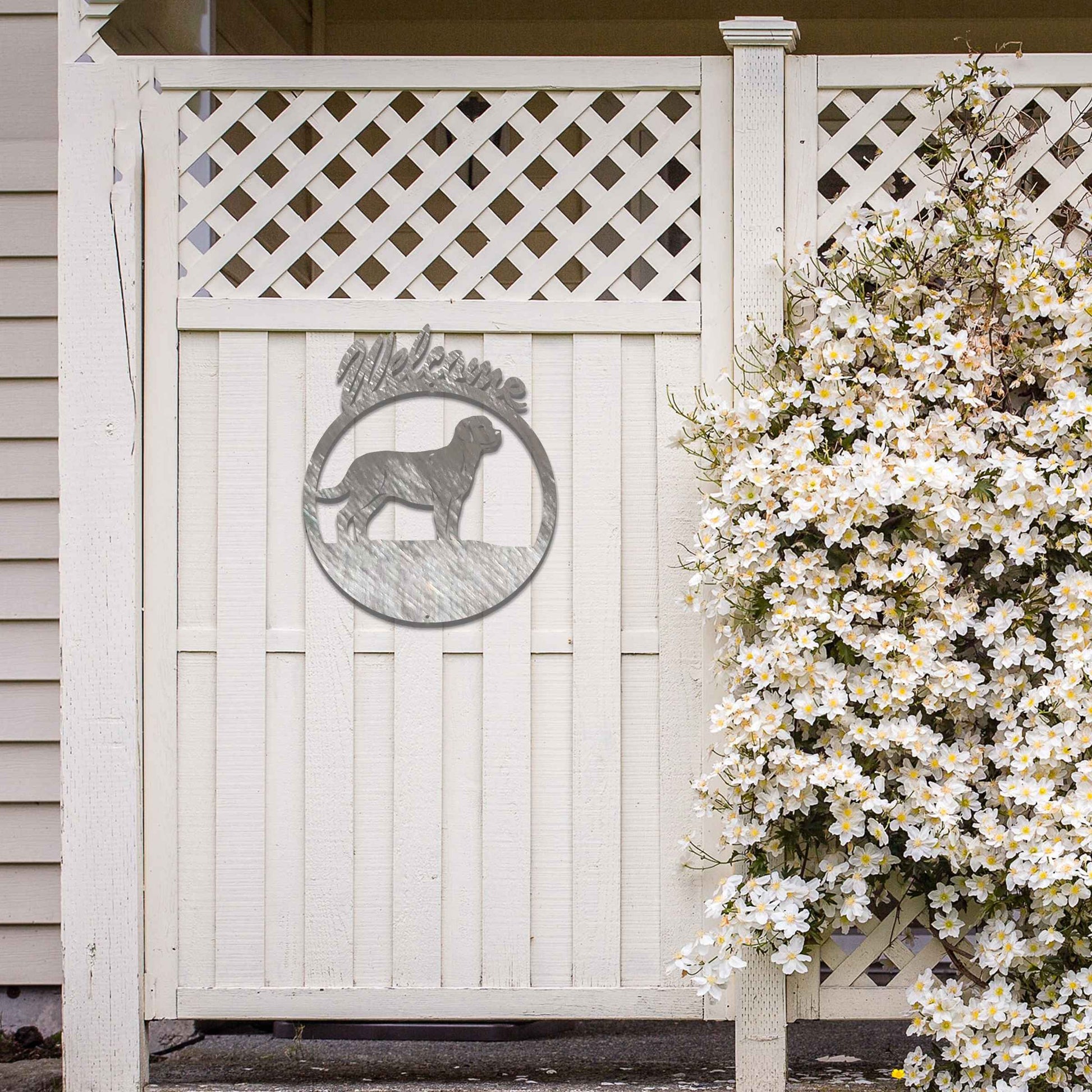 Metal garden art design showcasing a dog silhouette in profile, enclosed within a circular frame. Above the dog, the word Welcome is displayed, creating a warm and inviting atmosphere.