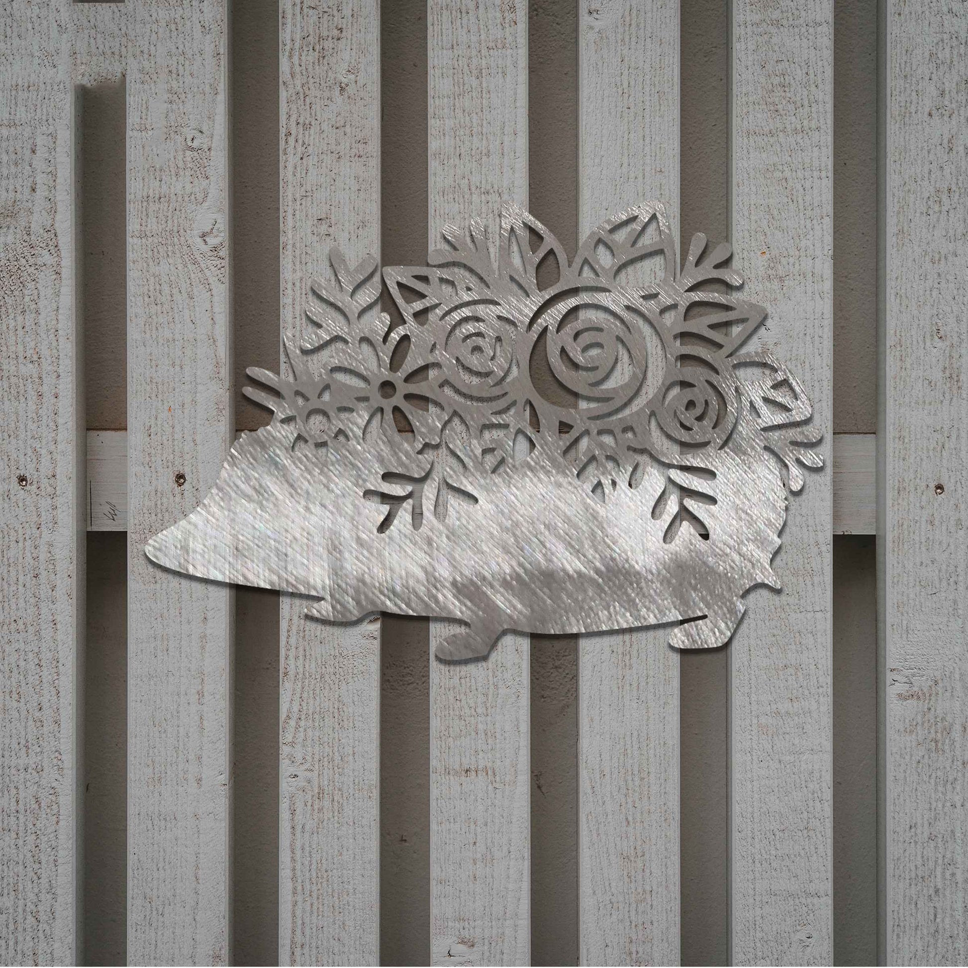 Metal garden decoration featuring a hedgehog-shaped design with intricate floral cutouts, adding a charming and rustic touch to outdoor spaces, perfectly blending with garden greenery.