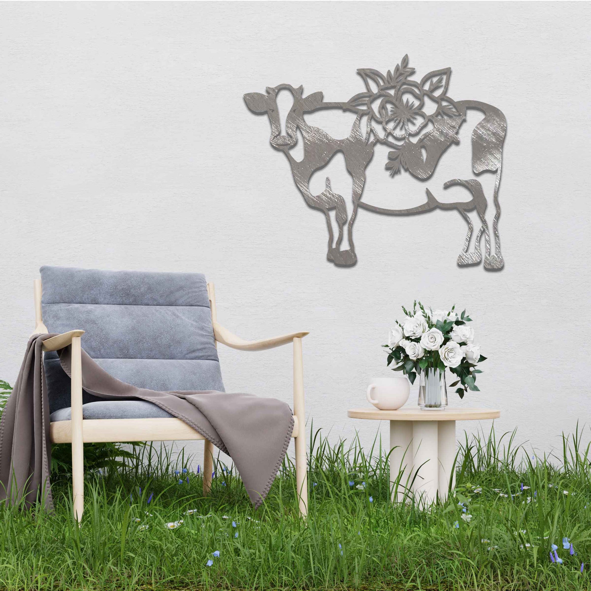 The artwork showcases a cow adorned with a detailed floral design on its back. The cow's form is outlined in a minimalist style, with the intricate flowers contrasting against its simple body, adding a decorative and natural element to the piece. 