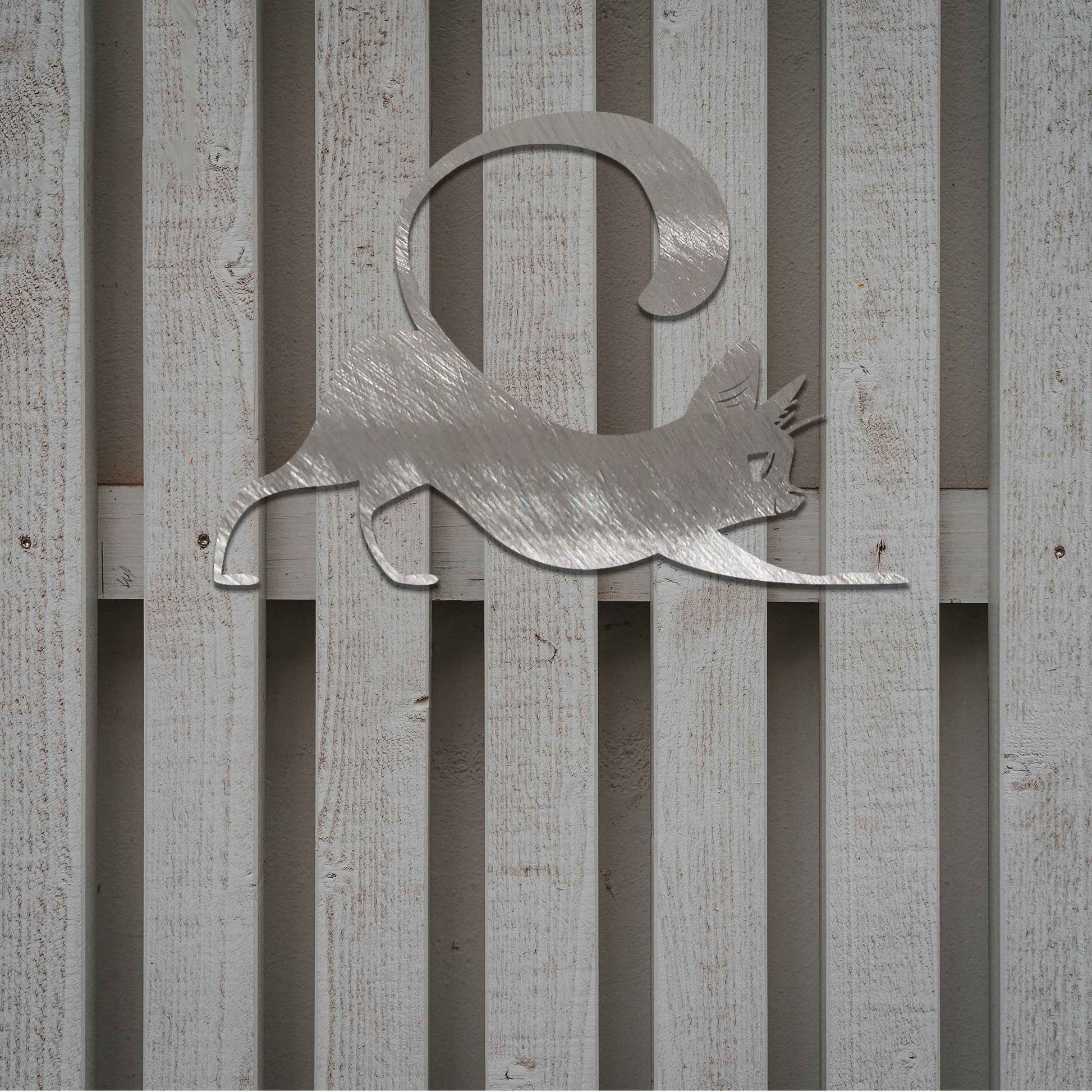 Metal garden decoration featuring a playful cat stretching with its tail curved upwards, crafted with sleek and elegant detailing, adding a touch of charm and liveliness to outdoor walls, fences, or doors.