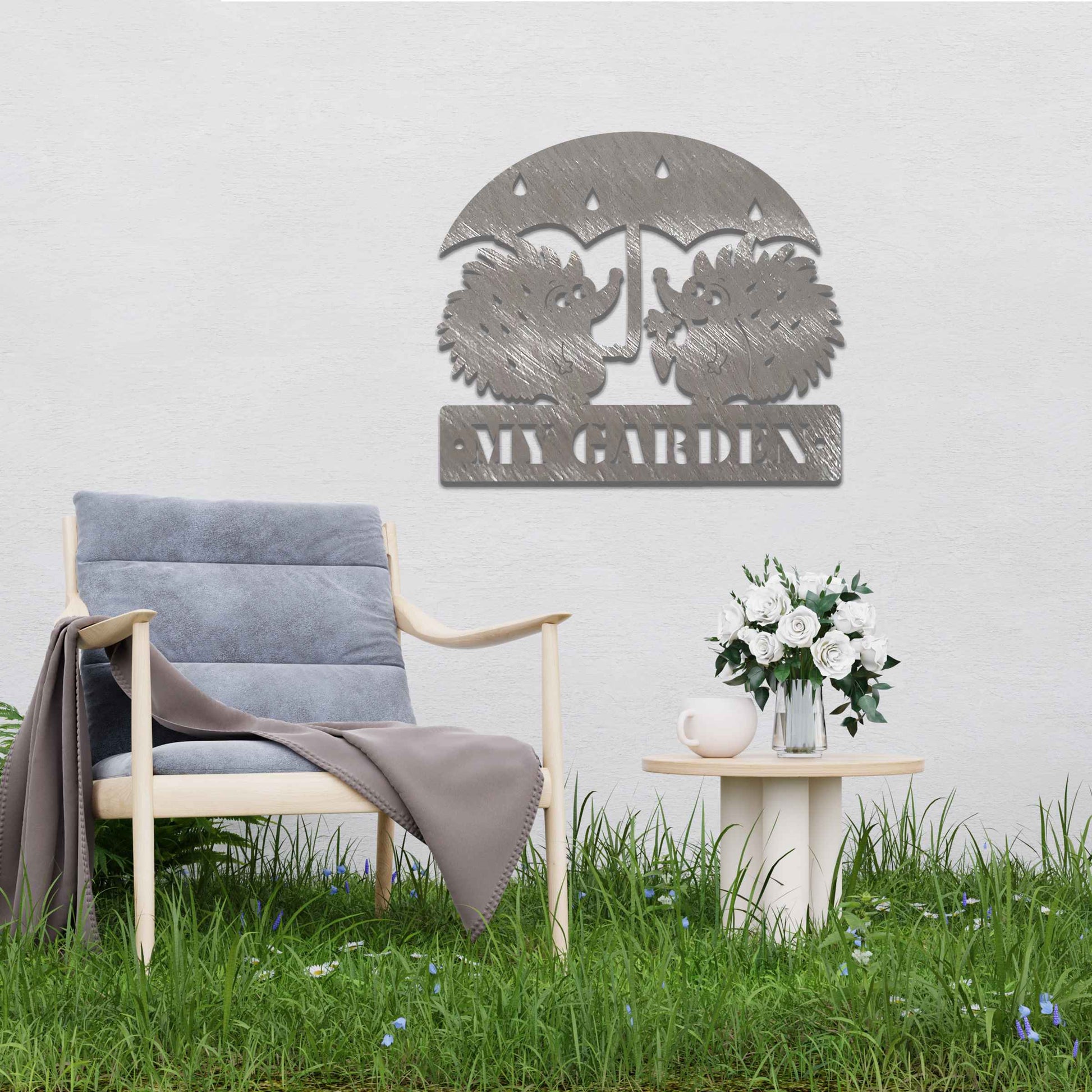 Metal garden decoration featuring two hedgehogs under an umbrella with raindrop details, accompanied by the word "Welcome," crafted with a rustic finish, adding a charming and inviting touch to outdoor spaces.