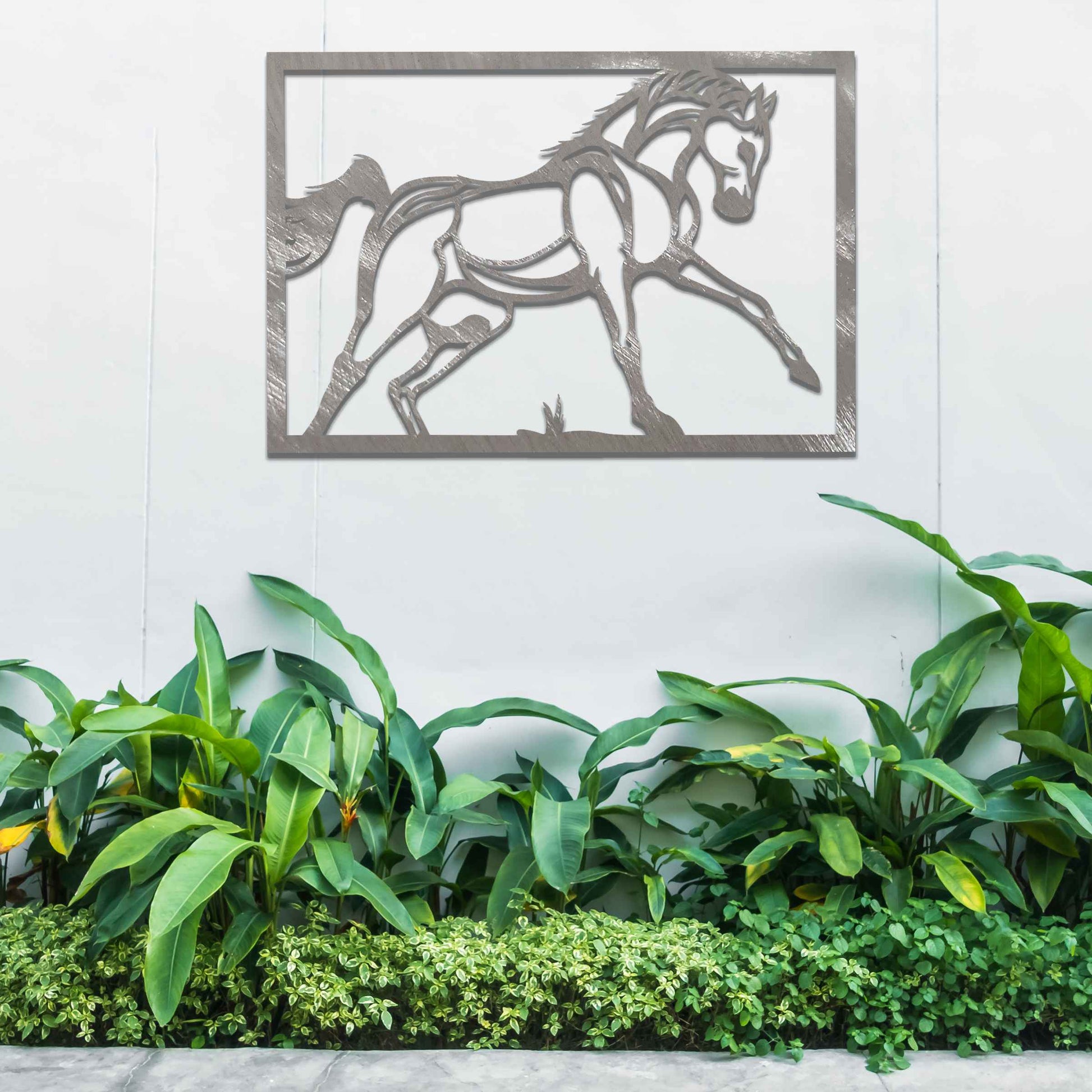 Metal wall art featuring an elegant horse in motion, outlined with bold lines and set within a rectangular frame. The artwork captures the graceful movement of the horse in a minimalistic style.