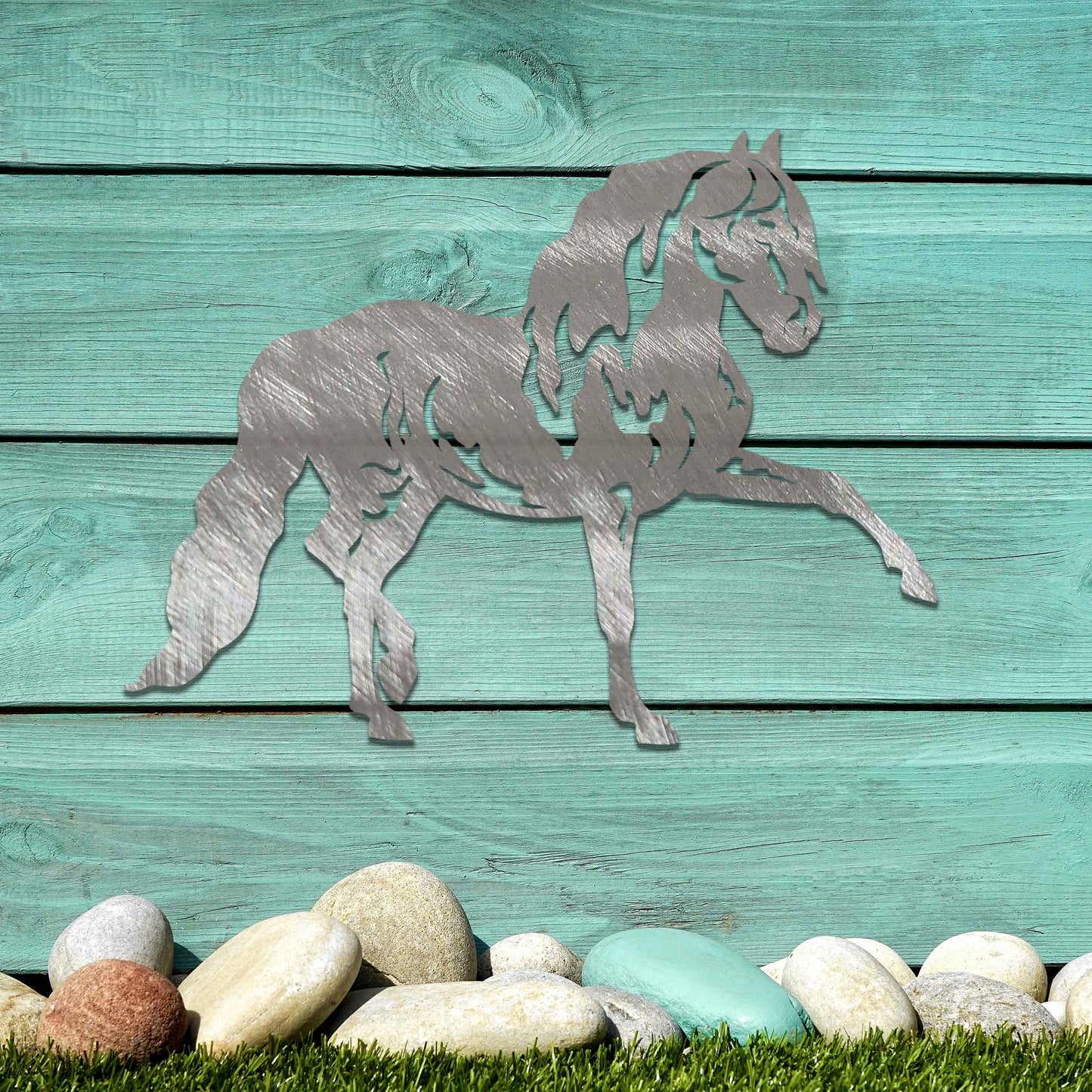 Metal wall art of a horse with a proud stance, featuring flowing mane and tail, captured in a dynamic pose. The design emphasizes strength and elegance, showcasing the horse's muscular form.