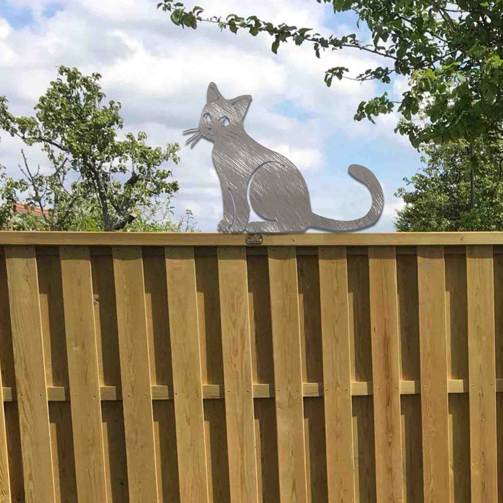 Metal garden decoration featuring a sitting cat silhouette with a rustic finish, designed to adorn fence tops or garden posts, adding a charming and playful touch to outdoor spaces.