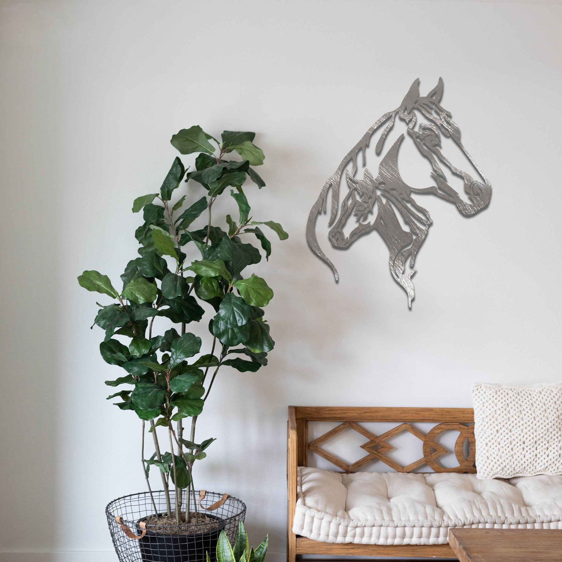 This metal wall art features two horse heads, one adult and one young, with elegant details showcasing their flowing manes and strong expressions. The design captures the connection and power of these majestic creatures.