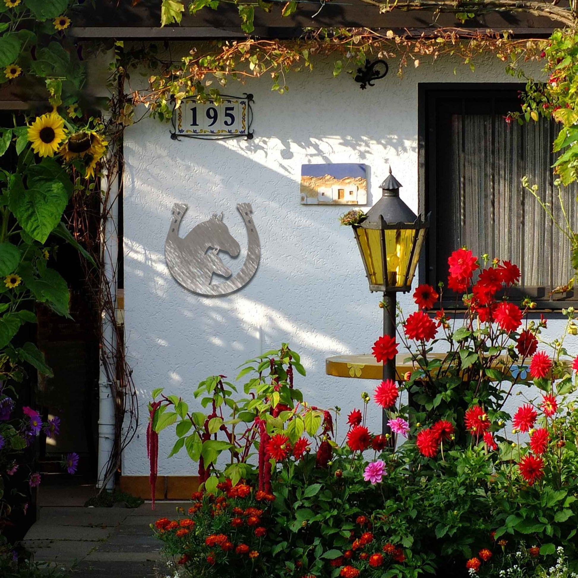 Metal garden decoration featuring a horse silhouette enclosed within a horseshoe design, crafted with a rustic finish, adding a touch of equestrian charm and character to outdoor walls or garden spaces