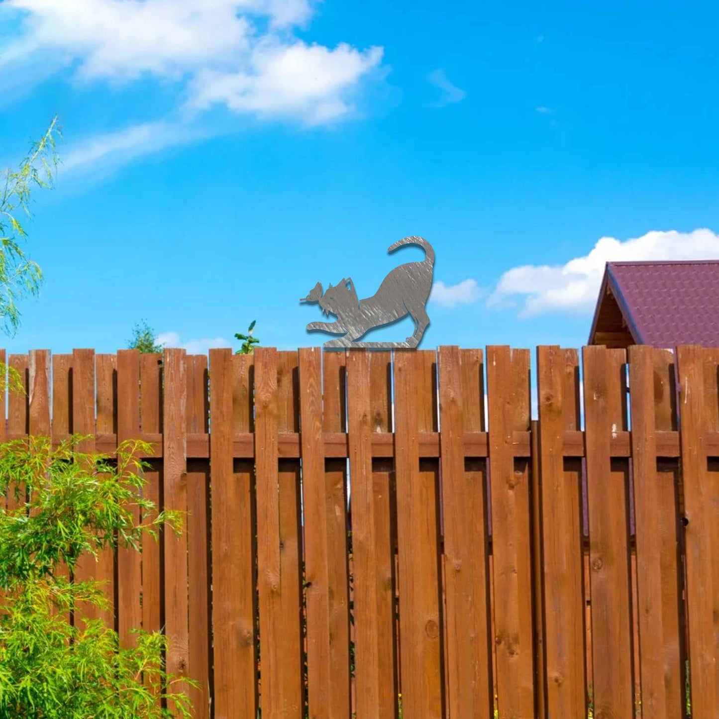 Metal garden decoration featuring a playful stretching cat silhouette with a rustic finish, designed to sit atop fences or posts, adding a whimsical and charming touch to outdoor garden settings.