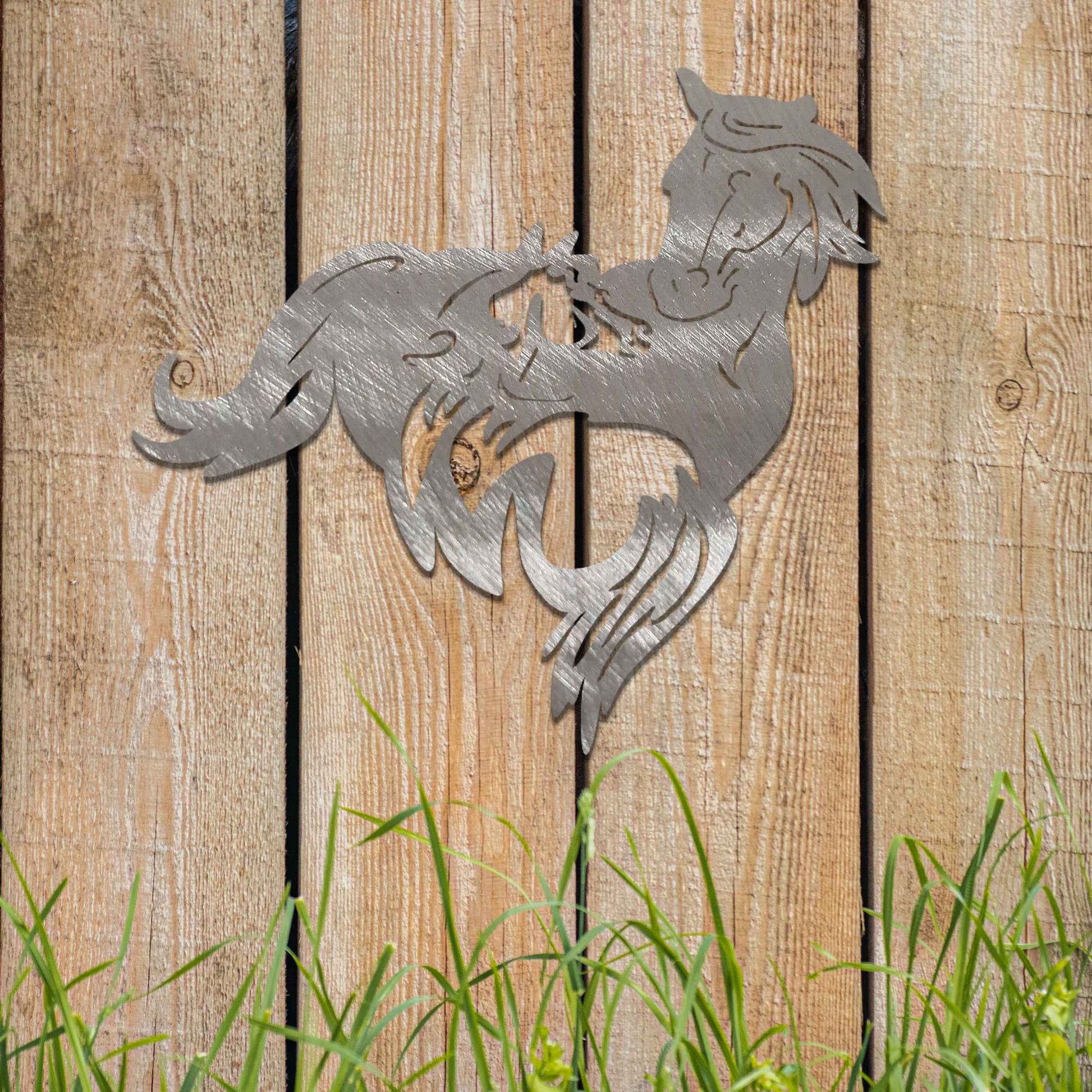 Metal wall decoration featuring a large horse with a smaller horse standing beside it, crafted with intricate cutout details and a rustic finish, adding a graceful and heartwarming touch to indoor or outdoor spaces.