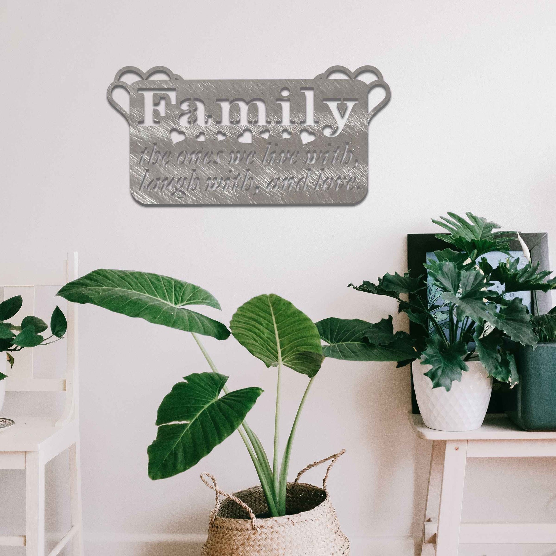 Metal wall decoration featuring the word "Family" and the phrase "the ones we live with, laugh with, and love," accented with heart details, adding a heartfelt and meaningful touch to indoor or outdoor spaces.