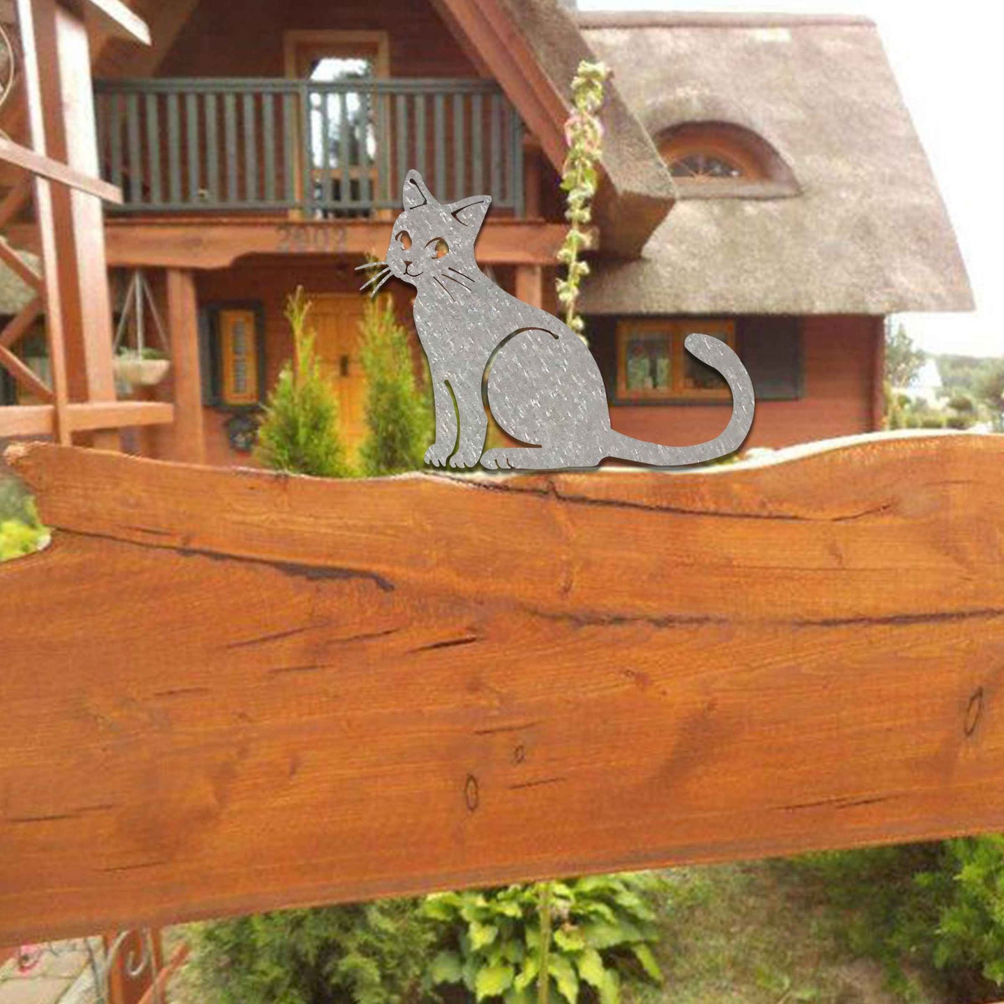 Metal garden decoration featuring a sitting cat silhouette with a rustic finish, designed to adorn fence tops or garden posts, adding a charming and playful touch to outdoor spaces.