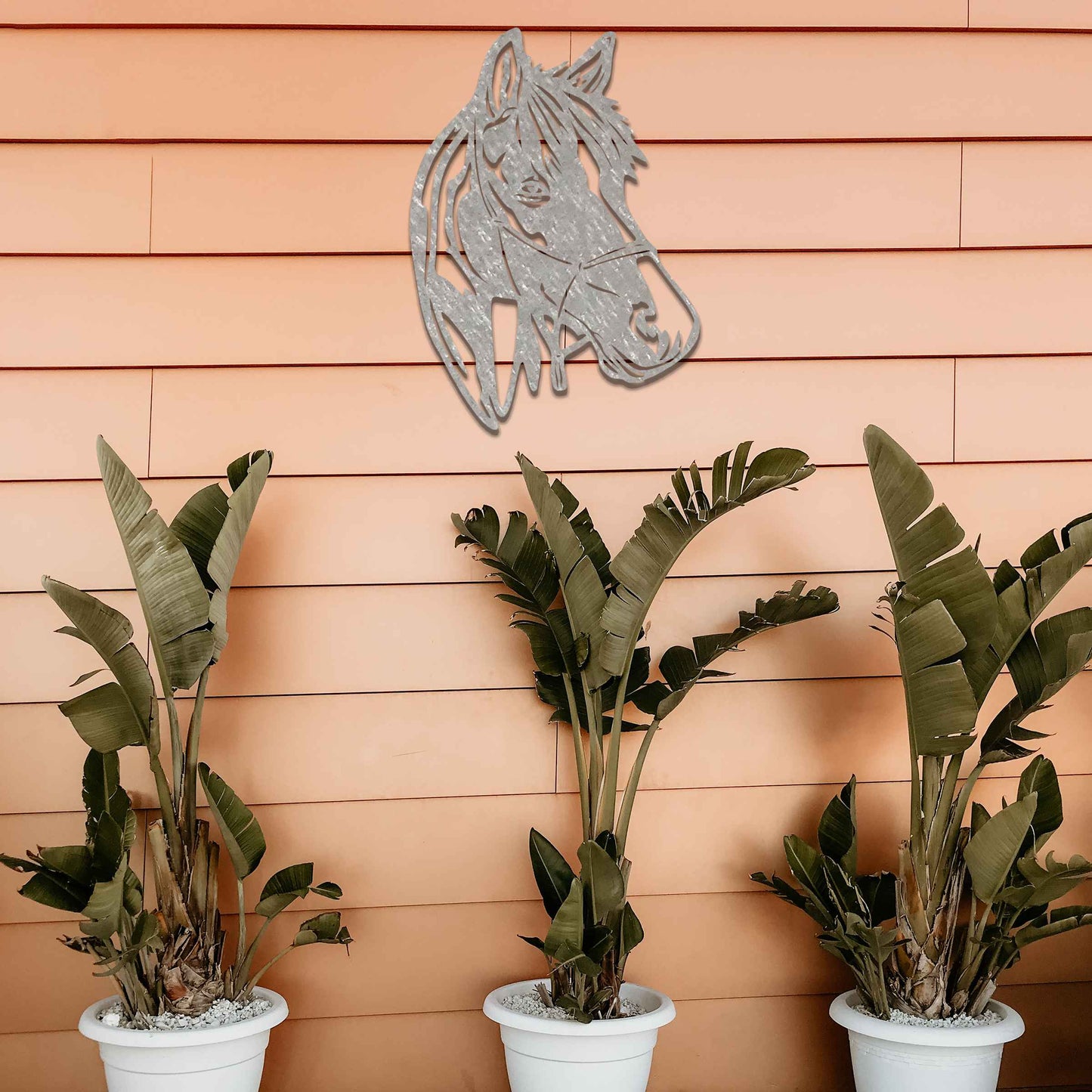 The design showcases the head of a horse in a minimalist style, highlighting its gentle expression and flowing mane. The silhouette captures the elegance and strength of the animal.
