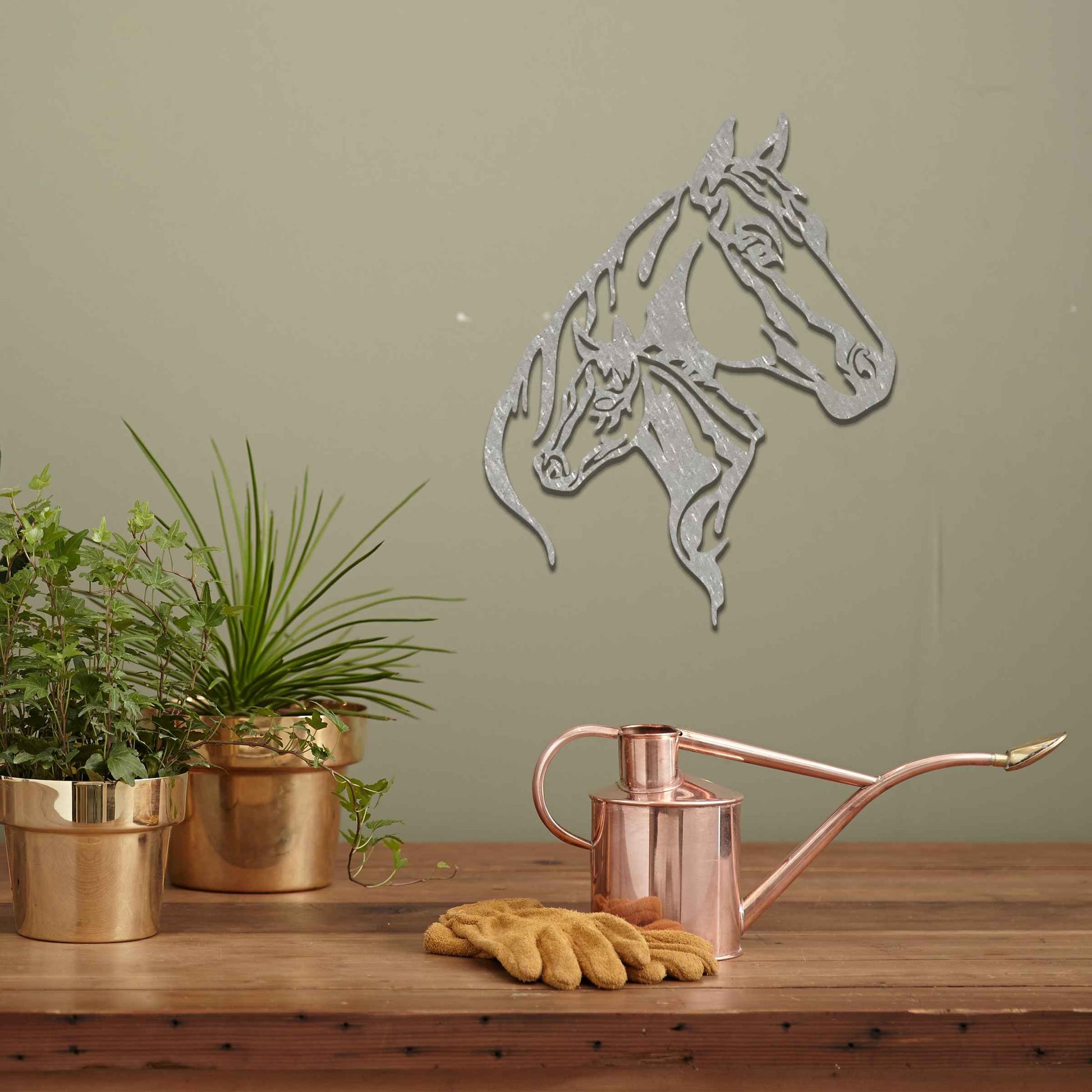 This metal wall art features two horse heads, one adult and one young, with elegant details showcasing their flowing manes and strong expressions. The design captures the connection and power of these majestic creatures.