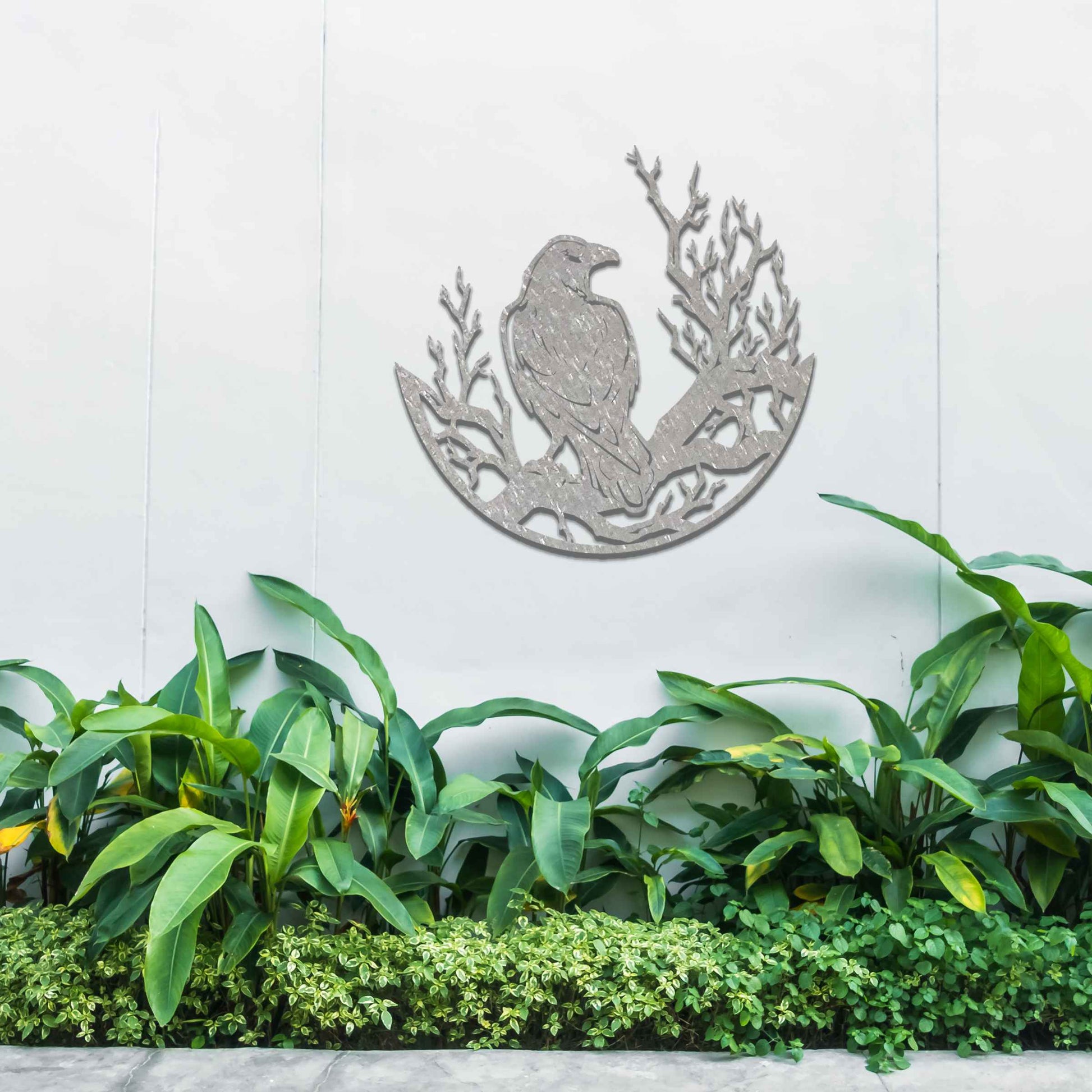 Metal wall decoration featuring a crow perched on detailed tree branches within a circular frame, crafted with intricate cutouts and a rustic finish, adding a bold and artistic touch to indoor or outdoor spaces.
