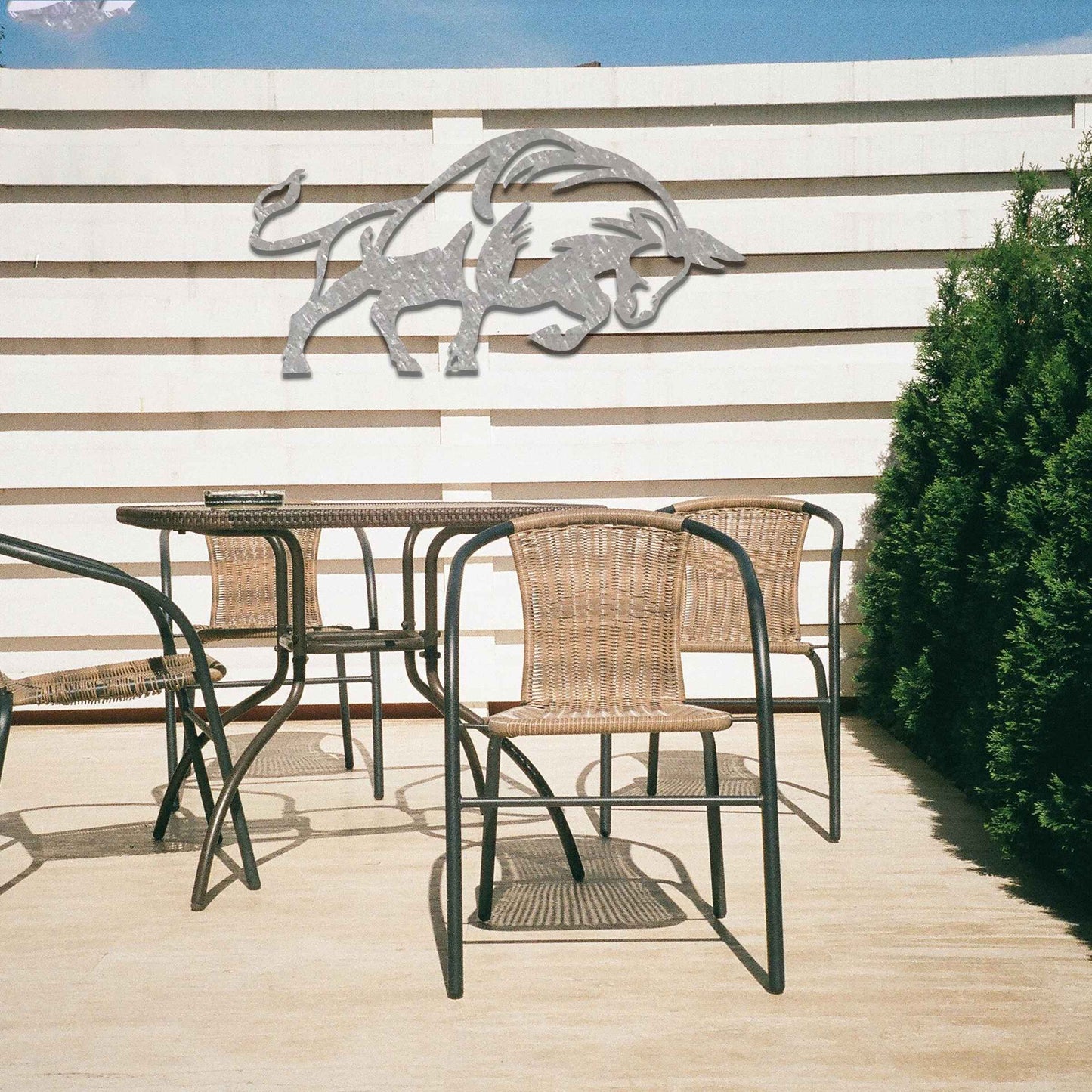 The design presents a powerful bull in motion, with strong, clean lines and a dynamic posture. The bull’s form is bold, enhanced with stylized elements that emphasize its strength. The natural rust finish adds a rugged and textured quality to the piece, accentuating its raw energy.