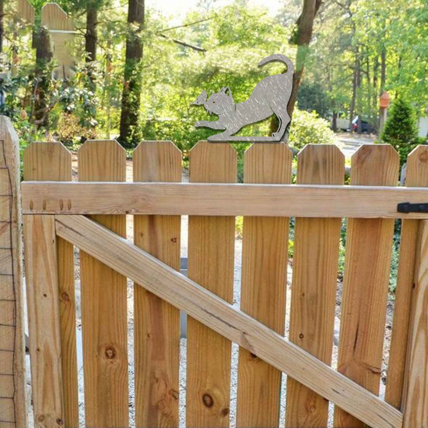 Metal garden decoration featuring a playful stretching cat silhouette with a rustic finish, designed to sit atop fences or posts, adding a whimsical and charming touch to outdoor garden settings.