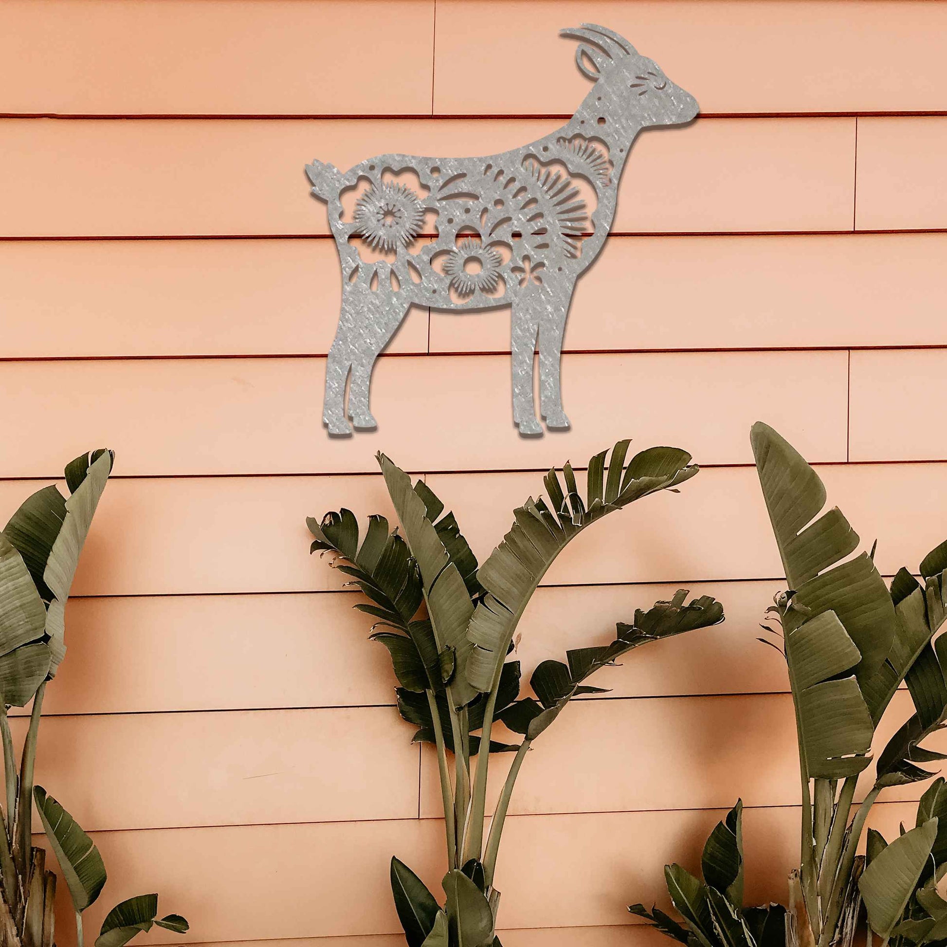 Side profile of a goat, beautifully adorned with intricate floral patterns along its body. The floral design enhances the natural grace of the animal, creating a charming and rustic piece of wall art.