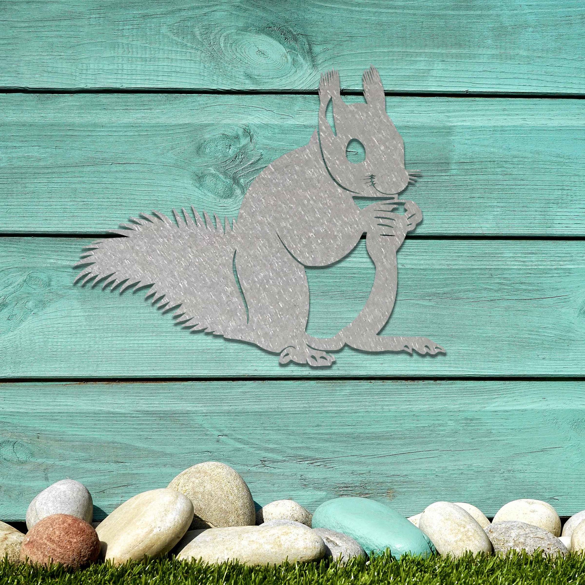 Metal wall decoration featuring a squirrel design with intricate details, adding a playful and artistic touch to indoor spaces, displayed on a neutral wall to highlight its elegant craftsmanship.
