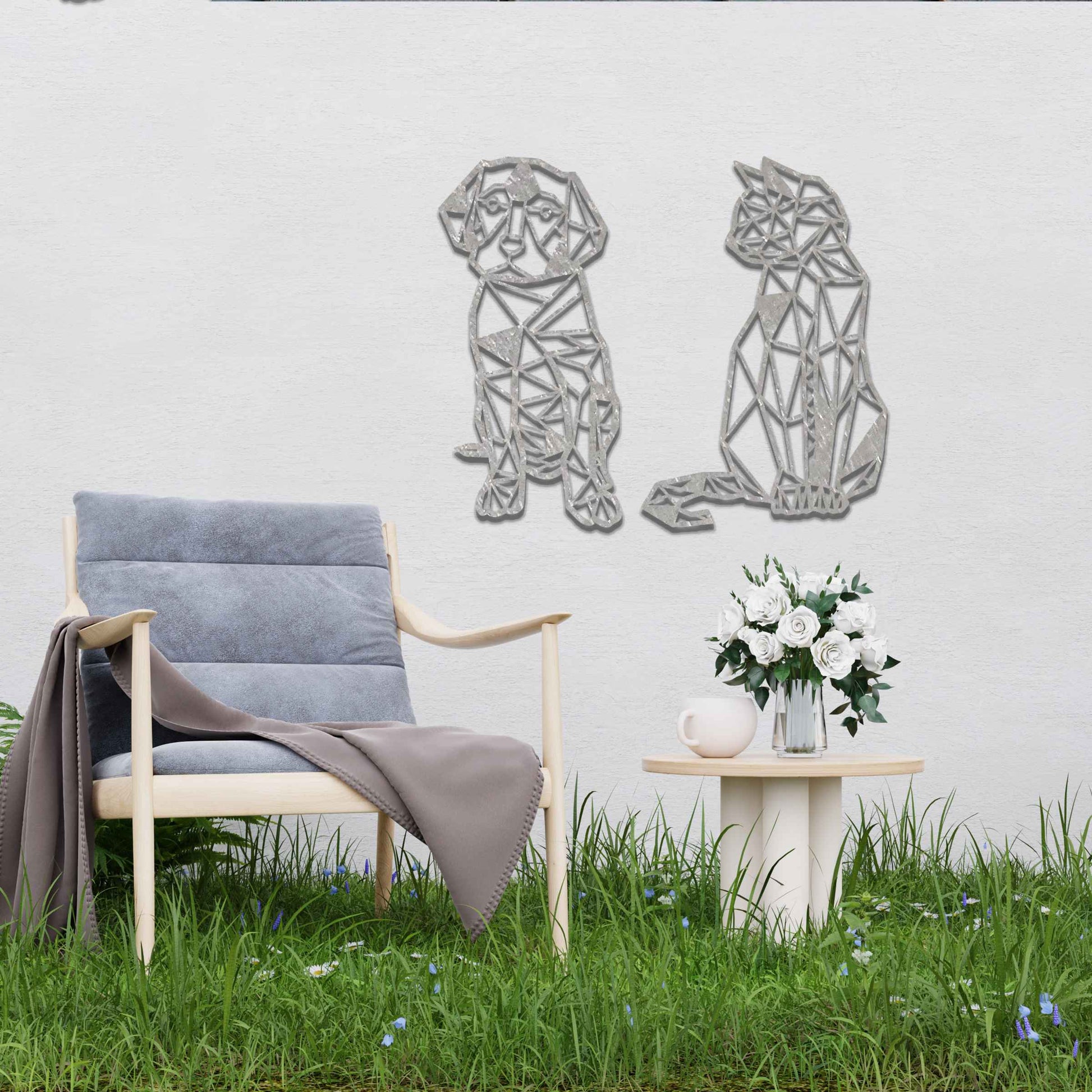 This image displays geometric-style black metal art featuring a dog and a cat, placed side by side. The angular, modern design of the animals contrasts beautifully with the natural greenery around, offering a stylish touch to the surrounding space.