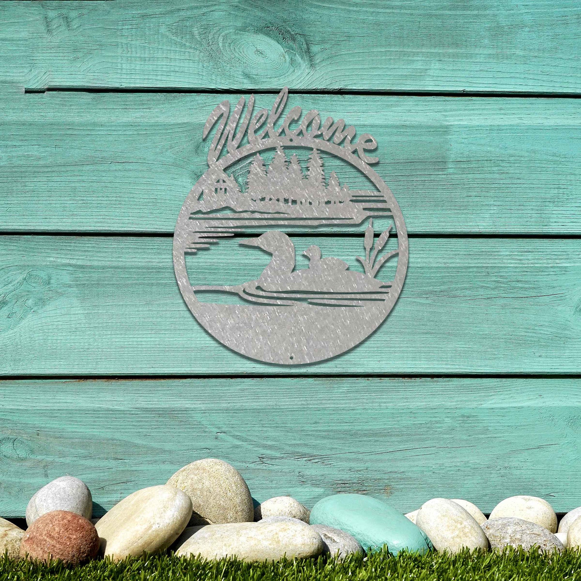 This design features two ducks in a water setting with the word "Welcome" above. The rustic finish adds charm, and the circular shape encapsulates the peaceful imagery, making it ideal for gardens or entrances.