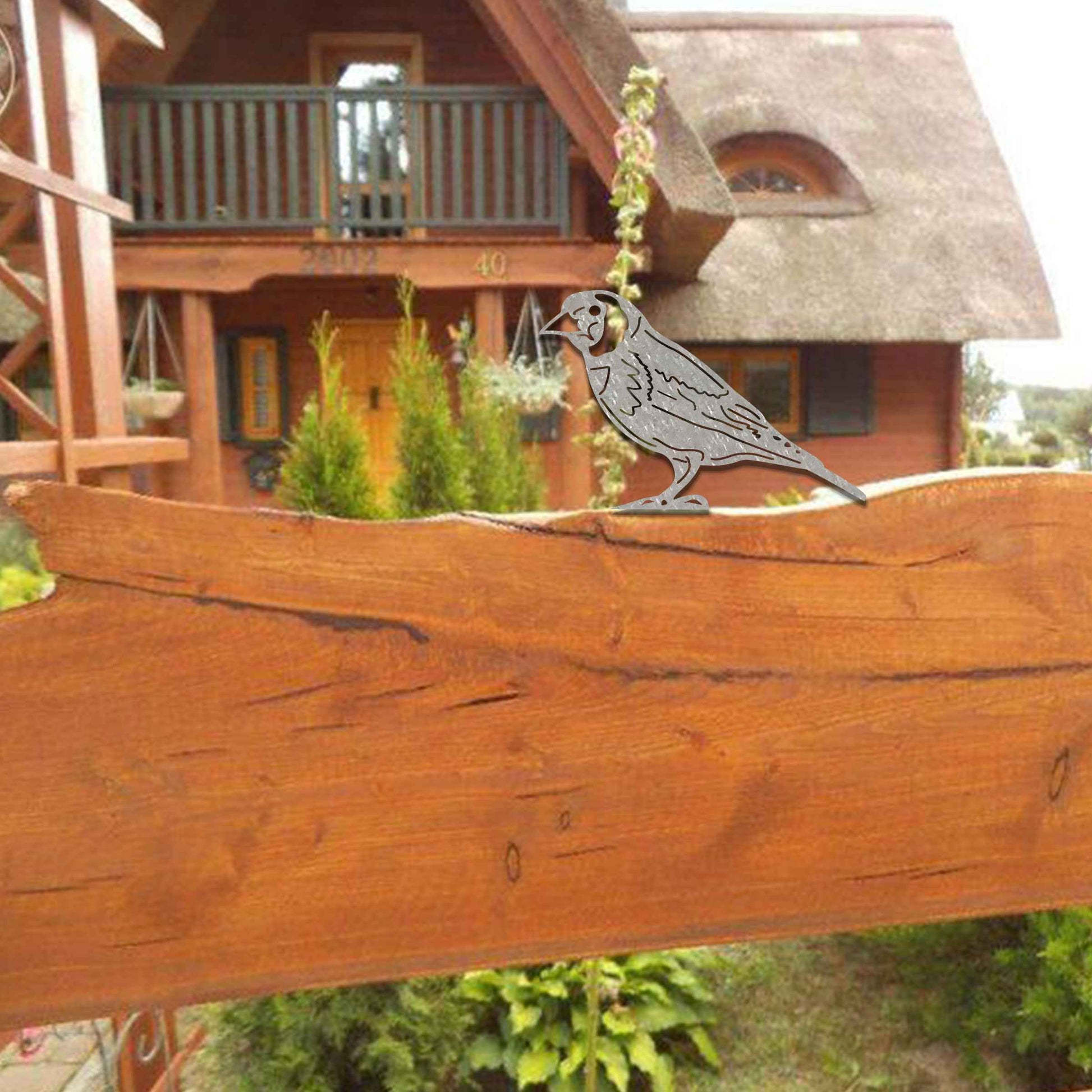 Metal garden decoration featuring a bird silhouette with a rustic finish, designed to sit atop fences or garden structures, adding a natural and artistic accent to outdoor spaces.