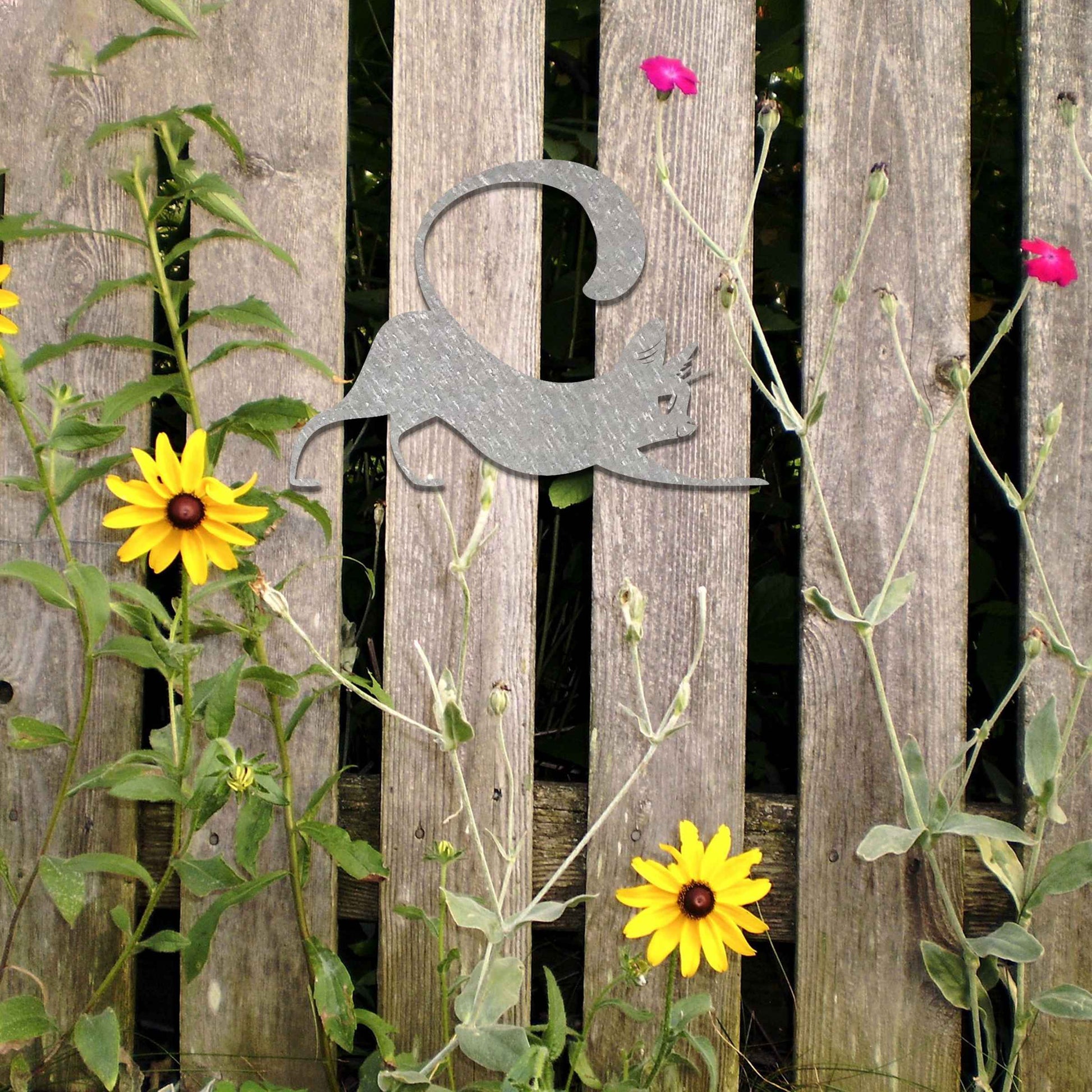 Metal garden decoration featuring a playful cat stretching with its tail curved upwards, crafted with sleek and elegant detailing, adding a touch of charm and liveliness to outdoor walls, fences, or doors.