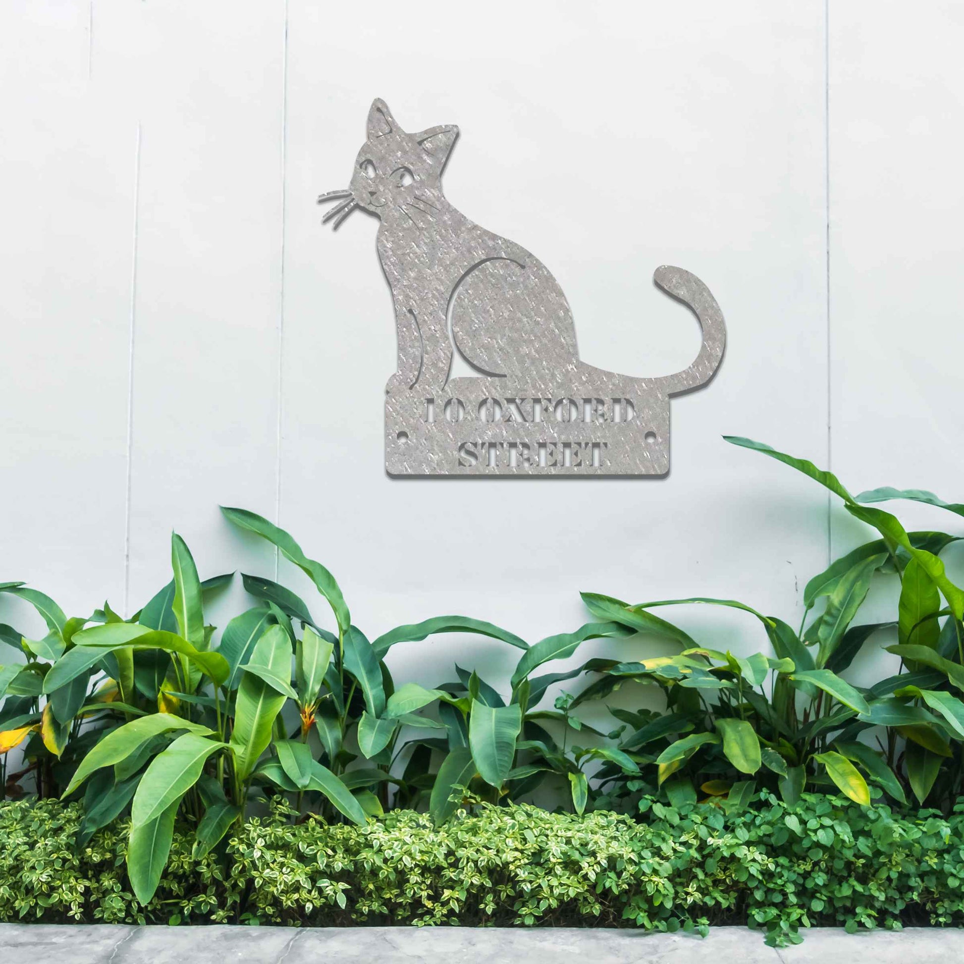 Metal garden decoration featuring a sleek sitting cat silhouette with a personalised address plaque, combining practicality with artistic charm for outdoor walls, fences, or gates.