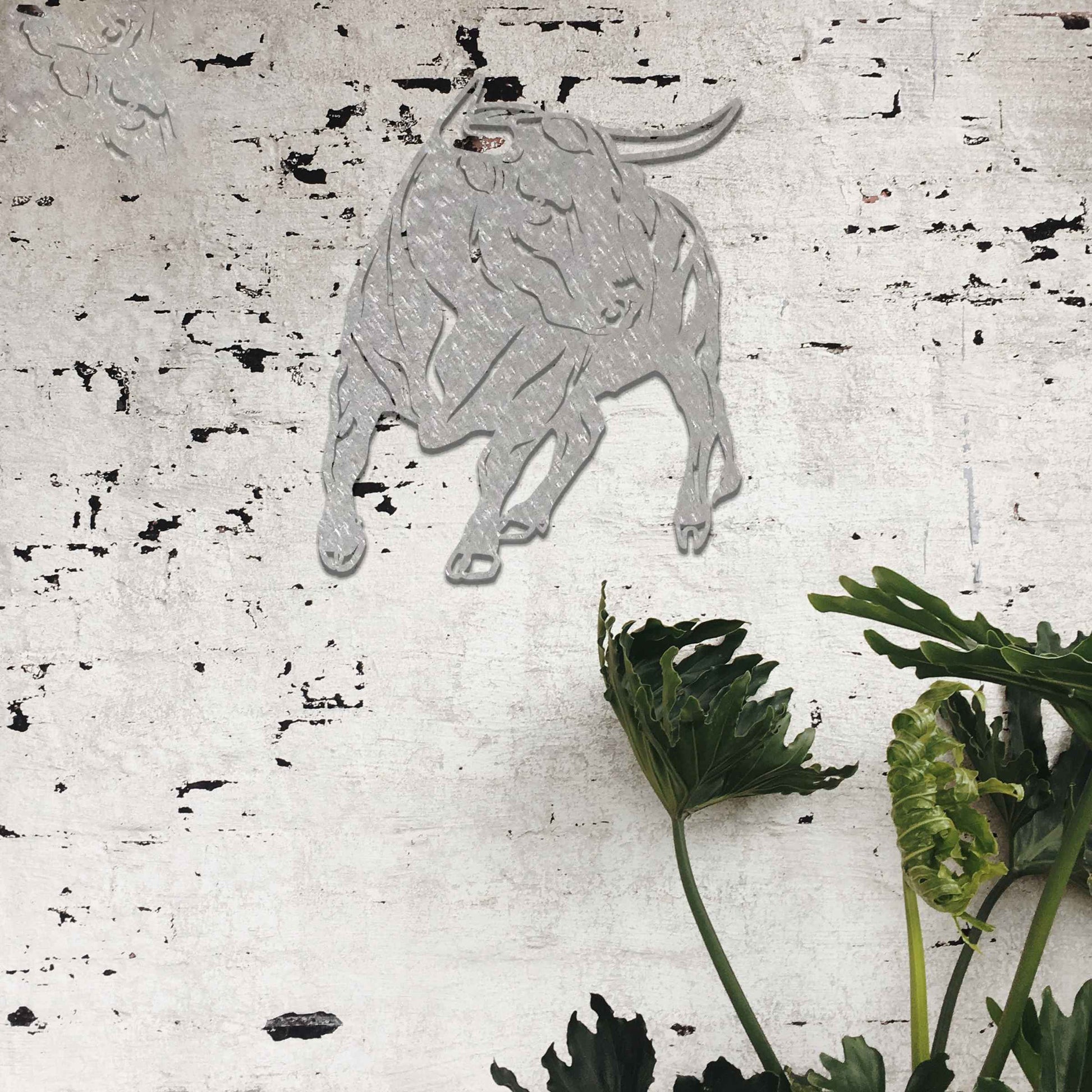 The design features a dynamic bull captured in a strong and assertive pose, showcasing its muscular build. The bull’s stance emphasizes power and movement, conveying a sense of energy and resilience.