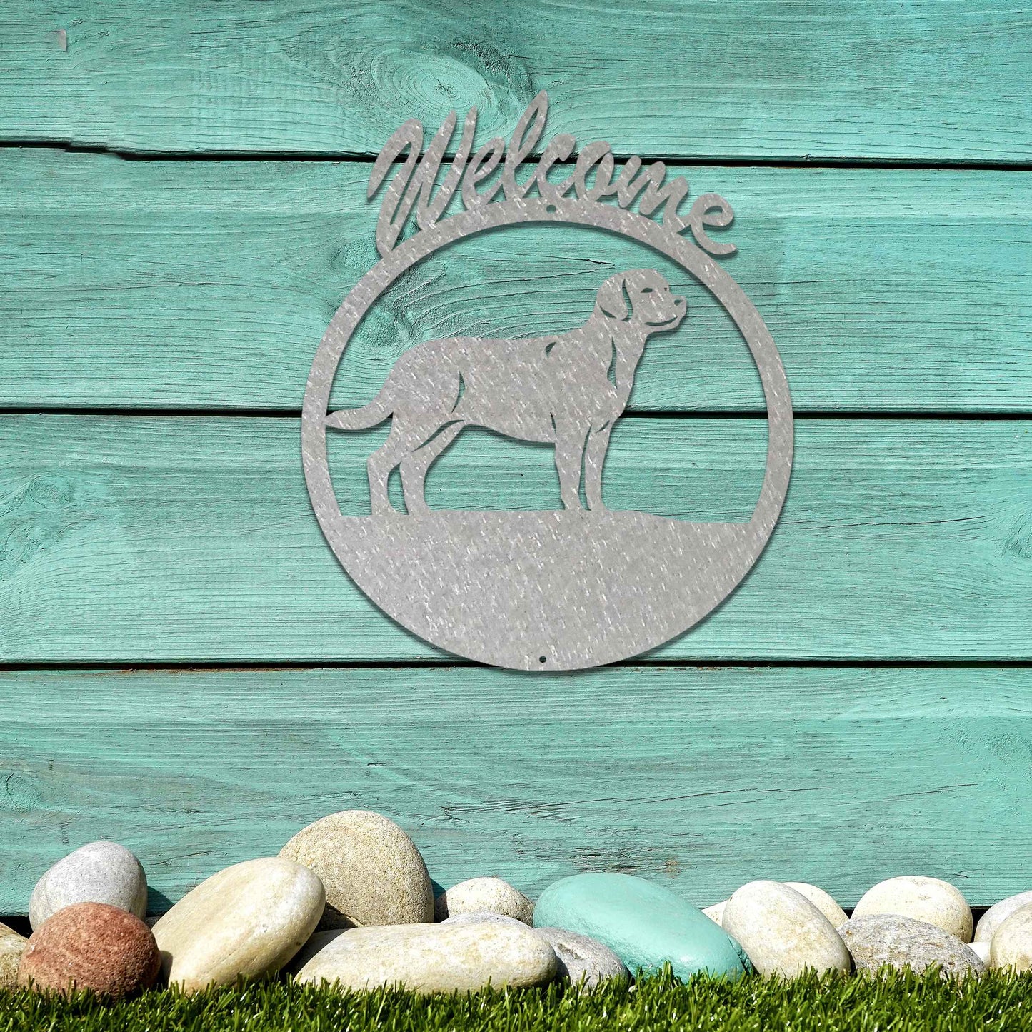 Metal garden art design showcasing a dog silhouette in profile, enclosed within a circular frame. Above the dog, the word Welcome is displayed, creating a warm and inviting atmosphere.