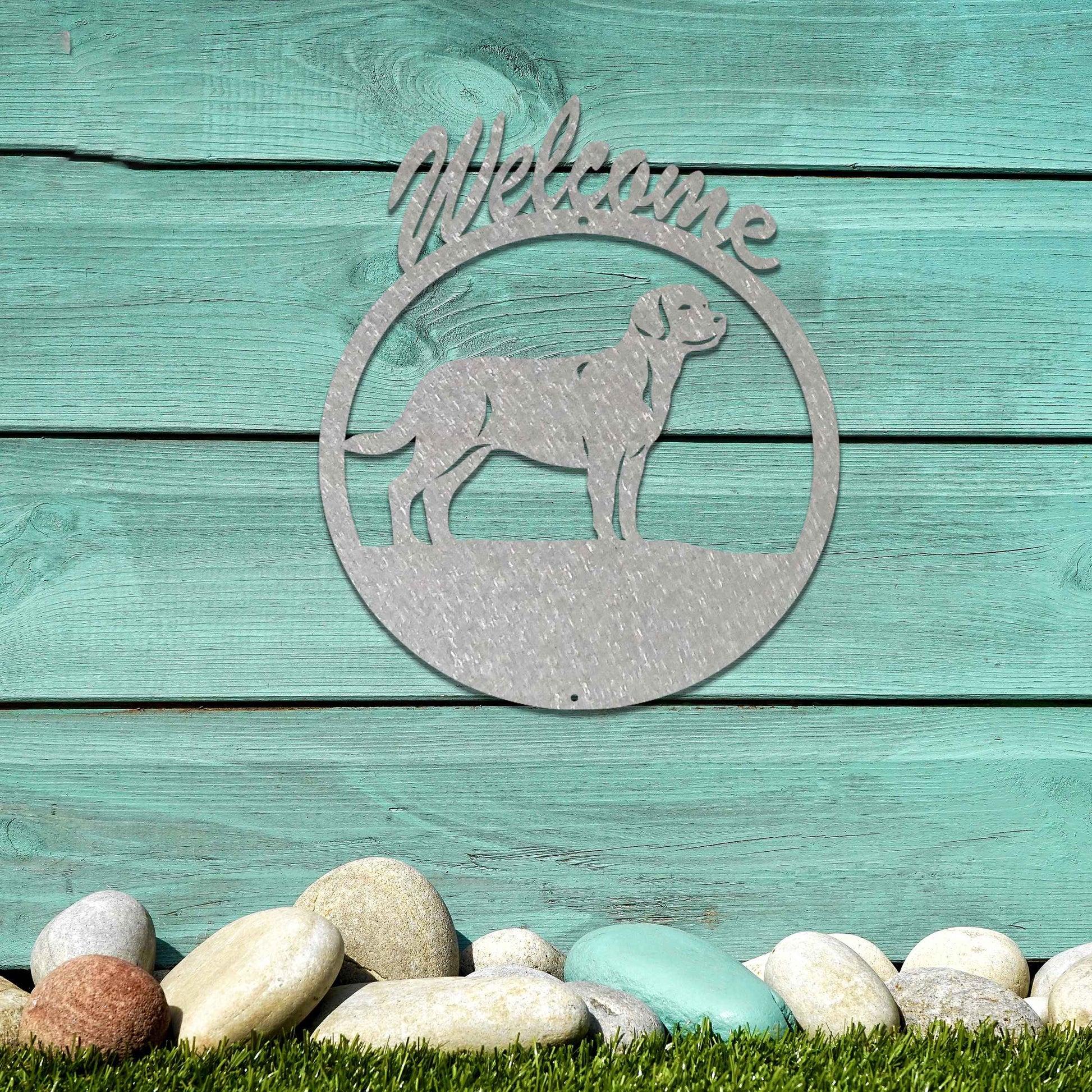 Metal garden art design showcasing a dog silhouette in profile, enclosed within a circular frame. Above the dog, the word Welcome is displayed, creating a warm and inviting atmosphere.
