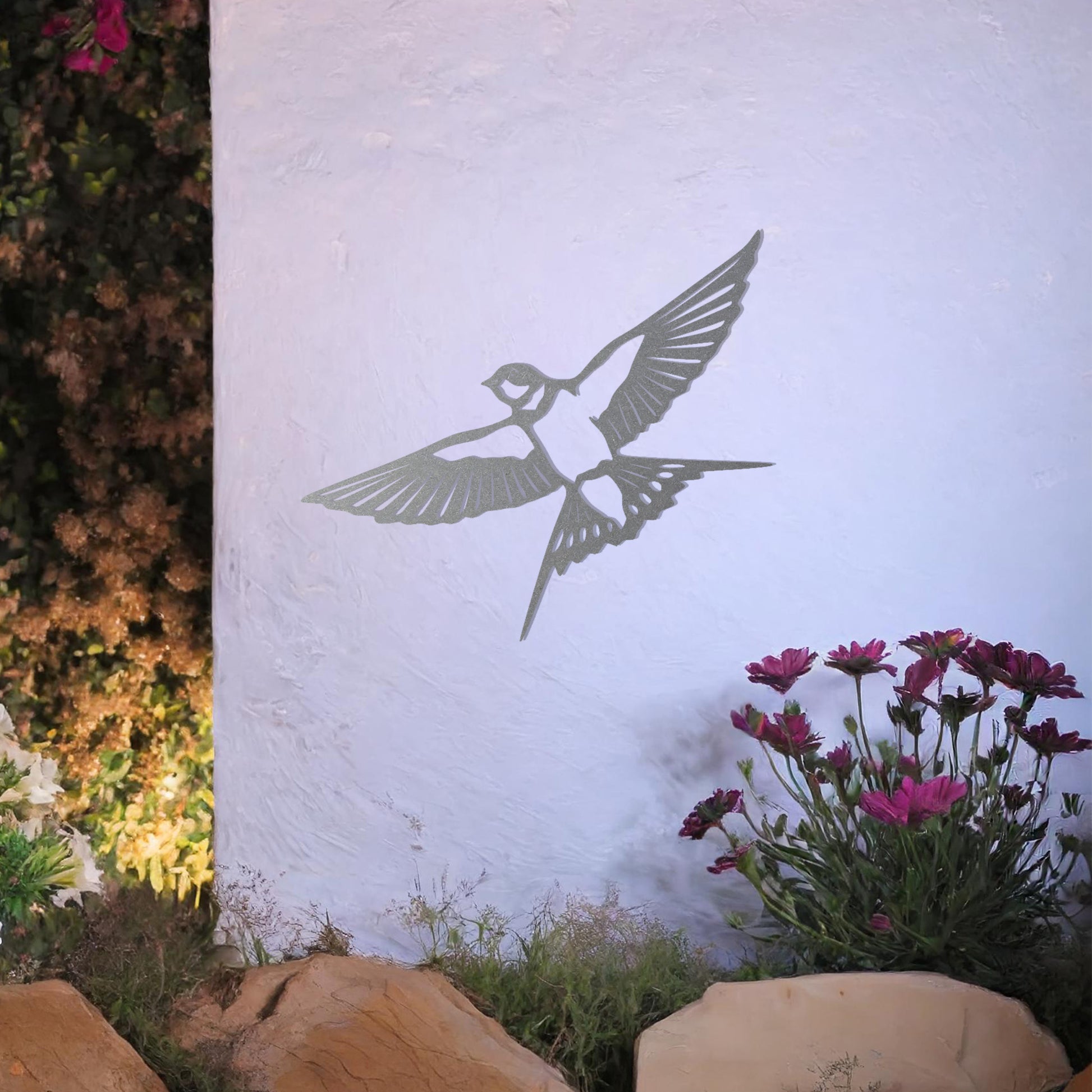 Metal garden decoration featuring a bird in mid-flight with detailed wings and tail, elegantly designed to bring a touch of nature-inspired charm and artistry to outdoor walls or garden settings.