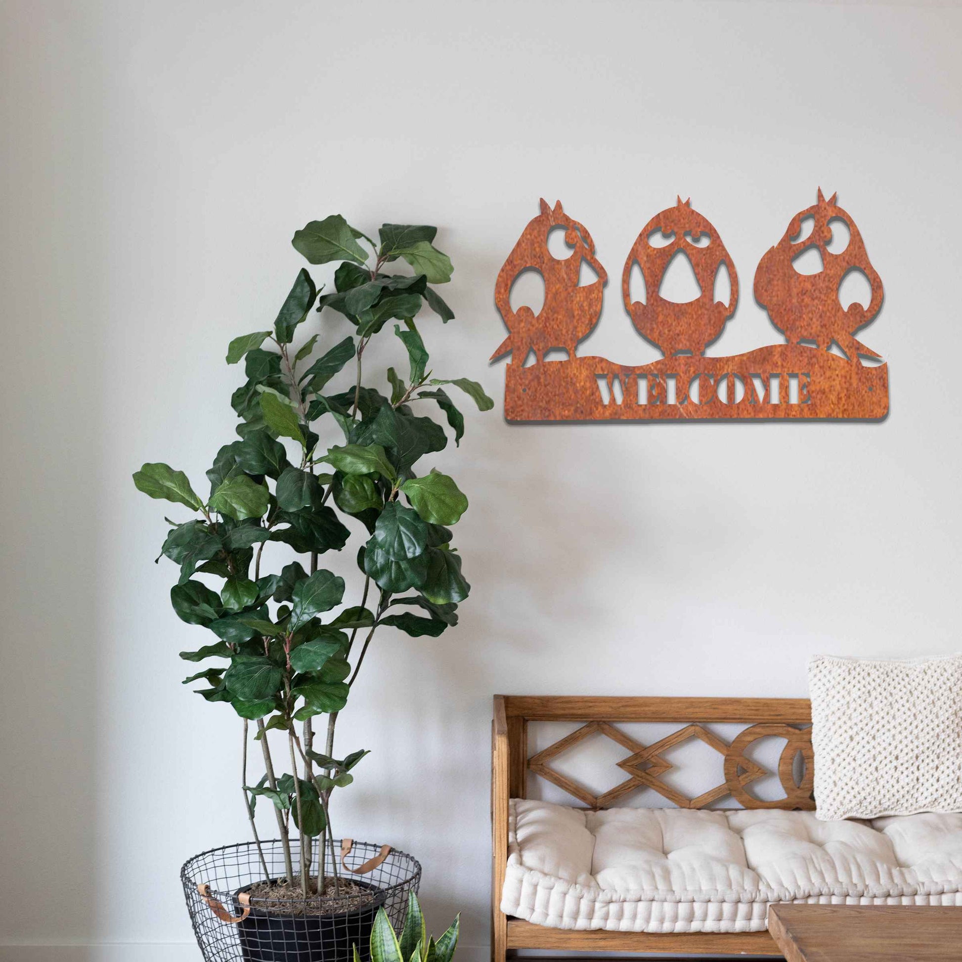 Metal garden decoration featuring three playful bird silhouettes perched on a customisable nameplate, adding a personalised and charming touch to outdoor walls, fences, or sheds.
