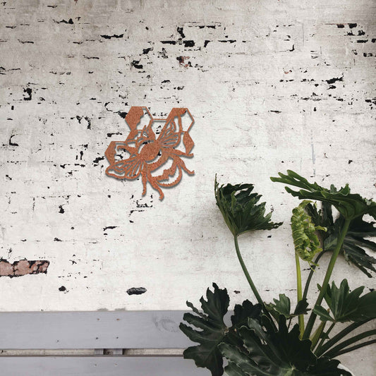 Metal garden decoration depicting a bee with honeycomb elements, intricately designed to enhance outdoor spaces, offering a blend of natural inspiration and rustic charm for garden or patio decor.