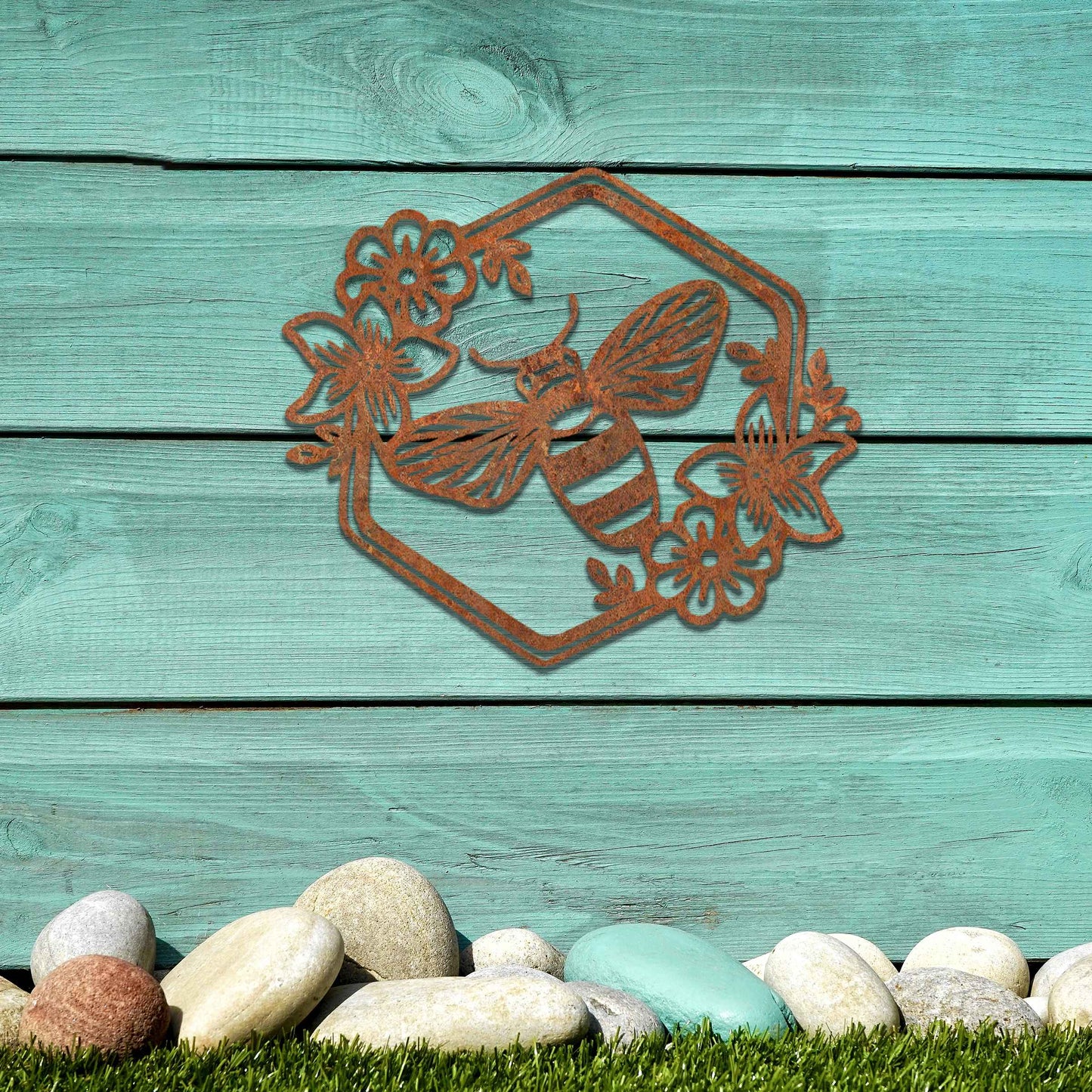 Metal garden decoration showcasing a bee design within a hexagonal frame, adorned with floral details, combining nature-inspired artistry and durability to enhance outdoor spaces with elegance and charm.