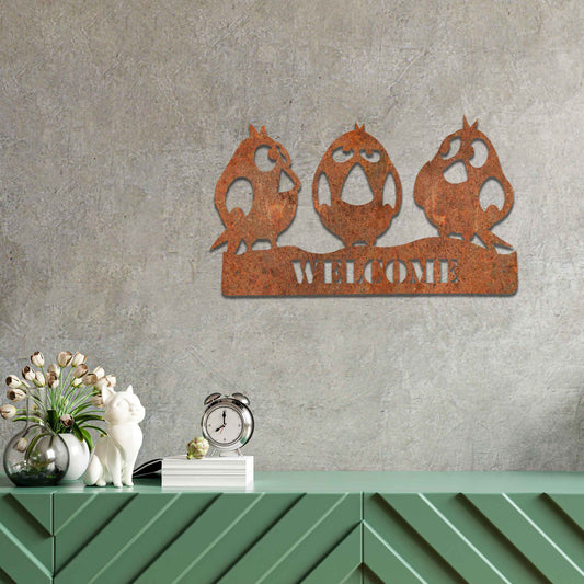 Metal garden decoration featuring three playful bird silhouettes perched on a customisable nameplate, adding a personalised and charming touch to outdoor walls, fences, or sheds.