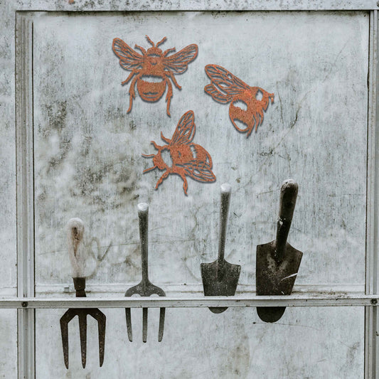 Set of metal garden decorations featuring three detailed bee designs, each showcasing intricate wing and body patterns, perfect for adding a playful and nature-inspired touch to outdoor spaces or fences.