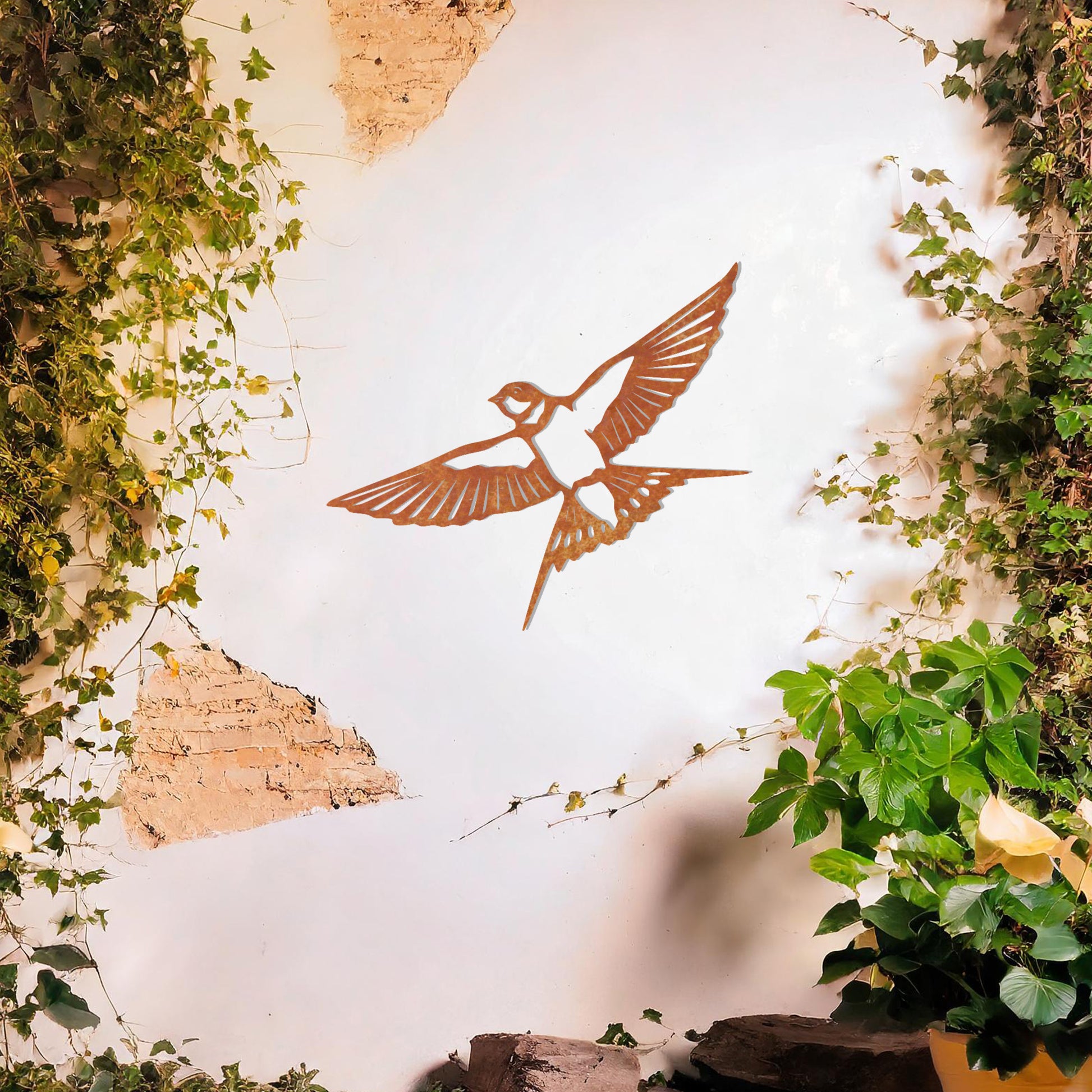 Metal garden decoration featuring a bird in mid-flight with detailed wings and tail, elegantly designed to bring a touch of nature-inspired charm and artistry to outdoor walls or garden settings.