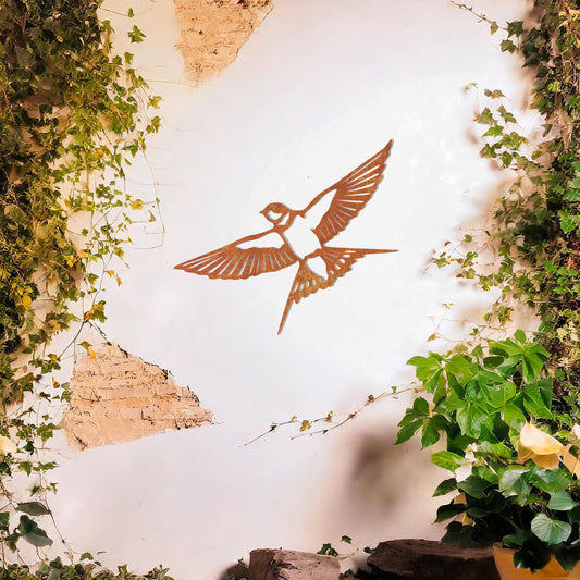 Metal garden decoration featuring a bird in mid-flight with detailed wings and tail, elegantly designed to bring a touch of nature-inspired charm and artistry to outdoor walls or garden settings.
