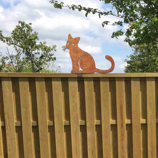 Metal garden decoration featuring a sitting cat silhouette with a rustic finish, designed to adorn fence tops or garden posts, adding a charming and playful touch to outdoor spaces.