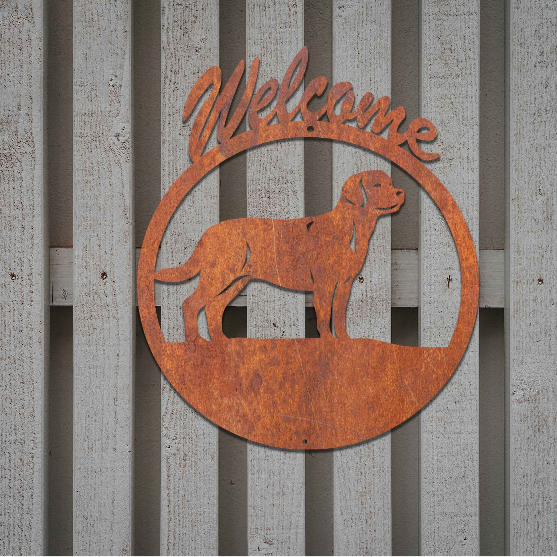 Metal garden art design showcasing a dog silhouette in profile, enclosed within a circular frame. Above the dog, the word Welcome is displayed, creating a warm and inviting atmosphere.