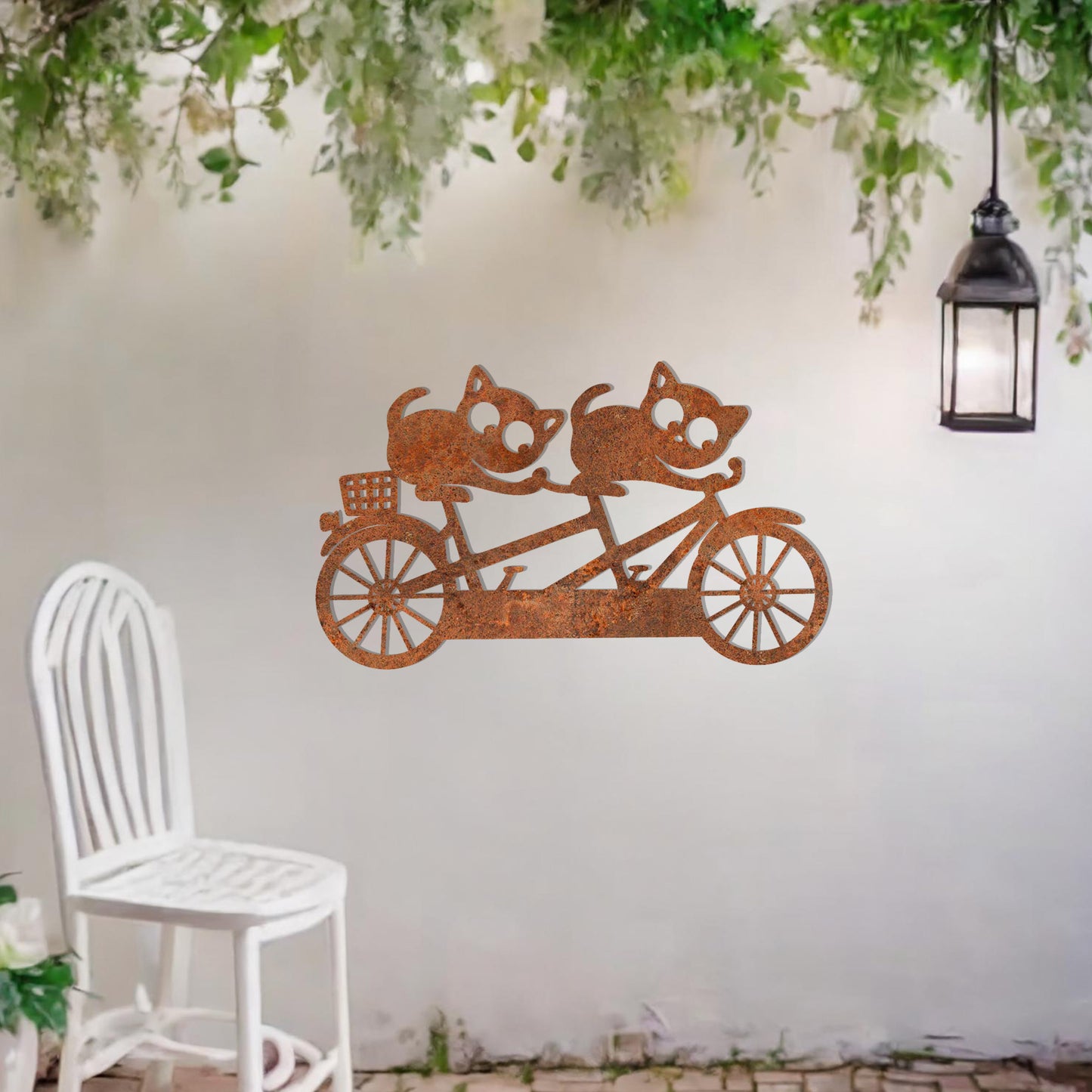 A charming metal wall art design depicting two playful cats riding a tandem bicycle, capturing a whimsical and fun moment with intricate details of the bike and expressive cat figures.