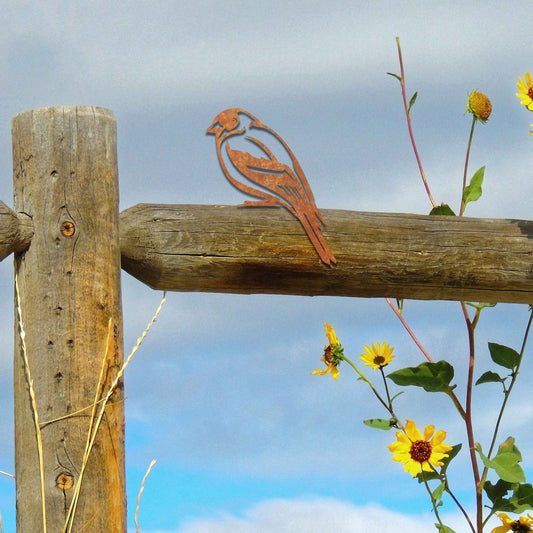 Metal garden decoration featuring a swallow silhouette with intricate cutout details and a rustic finish, designed to perch elegantly on wooden fences, adding a graceful and natural touch to outdoor spaces.