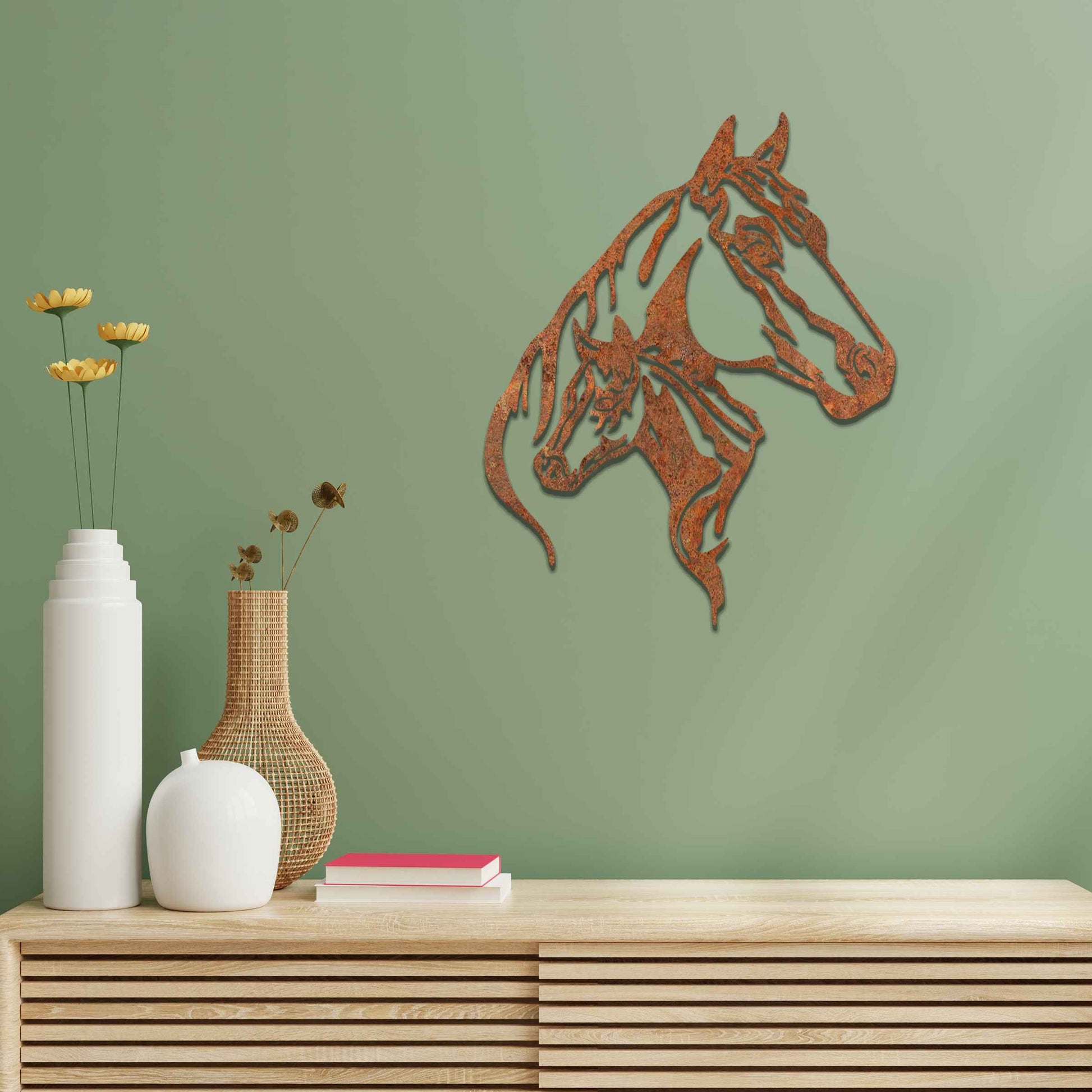 This metal wall art features two horse heads, one adult and one young, with elegant details showcasing their flowing manes and strong expressions. The design captures the connection and power of these majestic creatures.