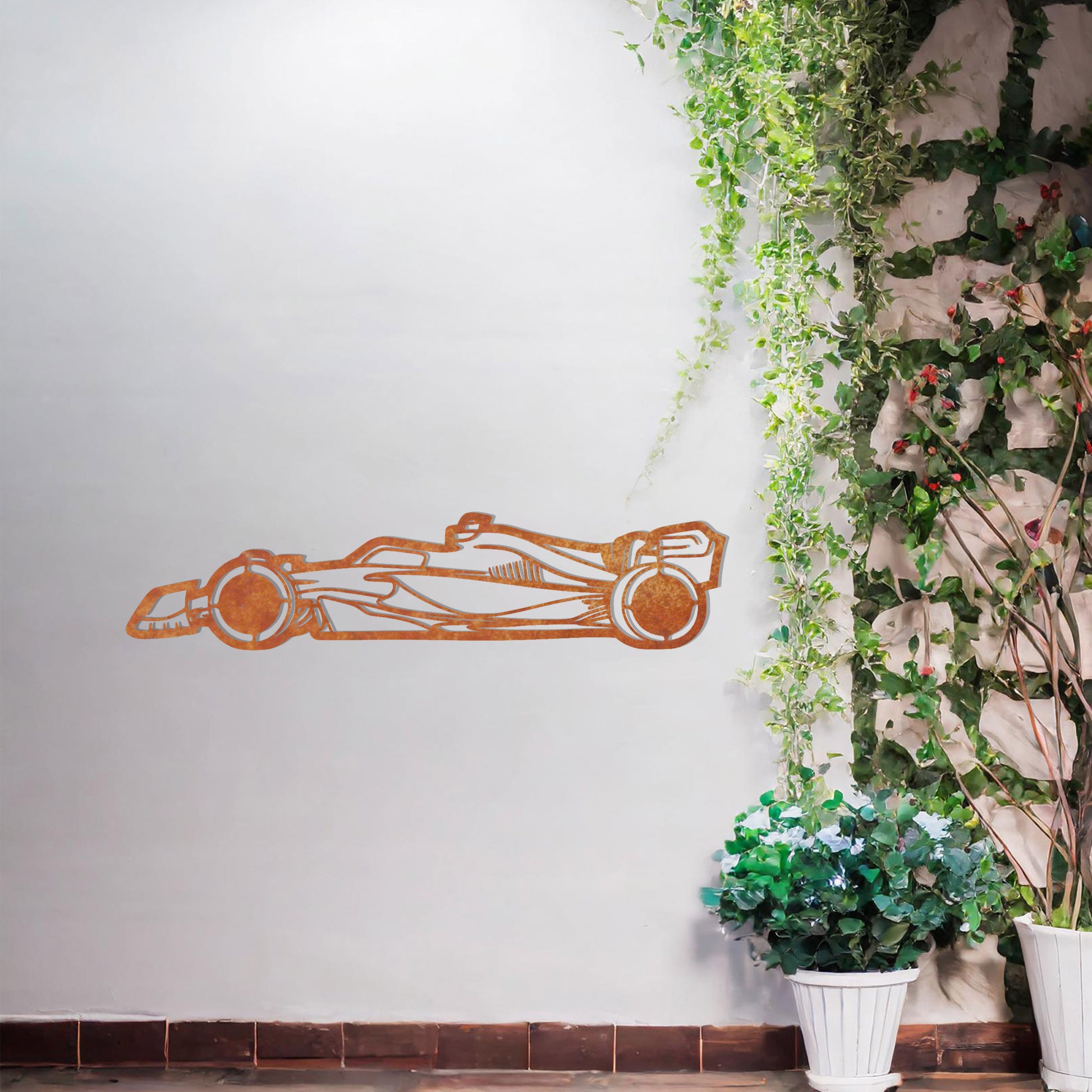 A sleek metal wall art design showcasing a detailed Formula 1 car silhouette. Perfect for motorsport enthusiasts, this artwork brings dynamic energy to modern or contemporary spaces. It is displayed on a neutral wall in a stylish outdoor setting.