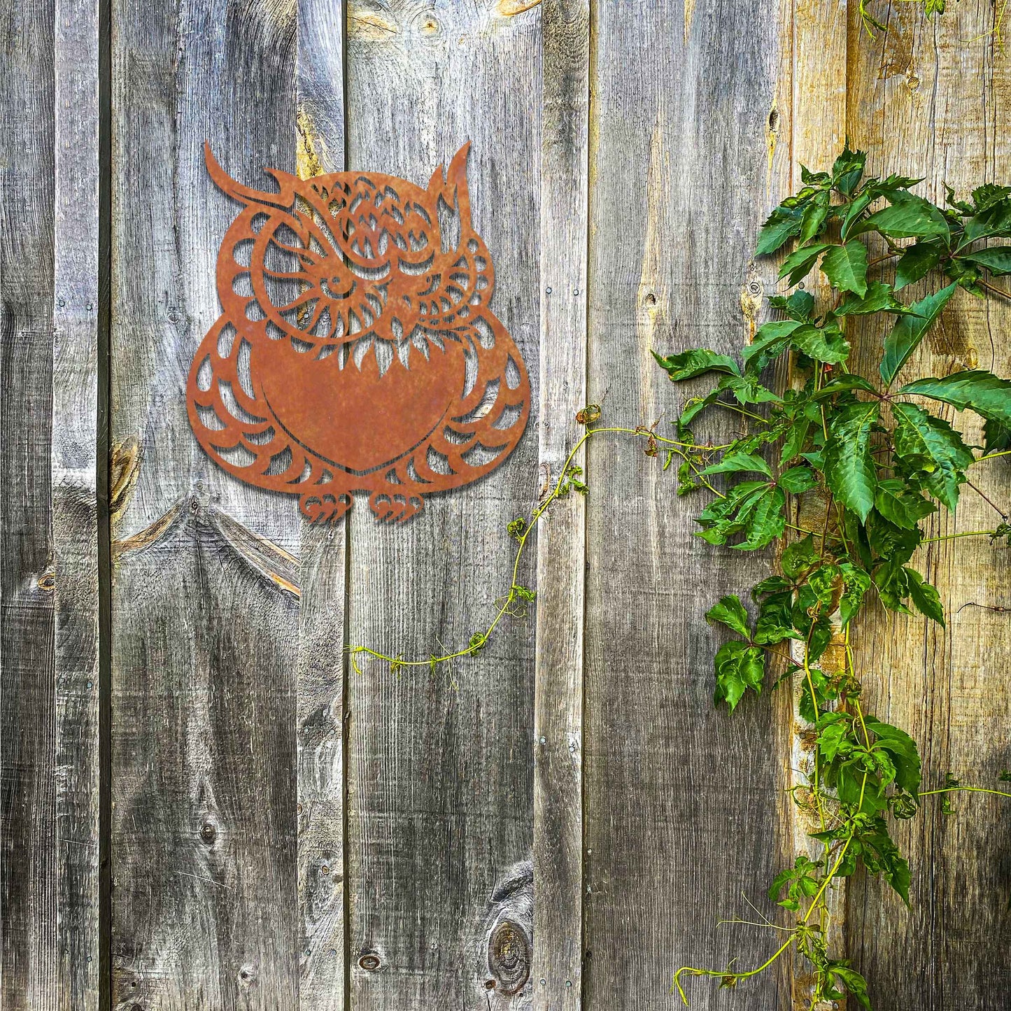 Metal garden decoration featuring a detailed owl design with intricate patterns, adding a touch of nocturnal charm and artistry to outdoor walls, enhancing the beauty of any garden or patio setting.